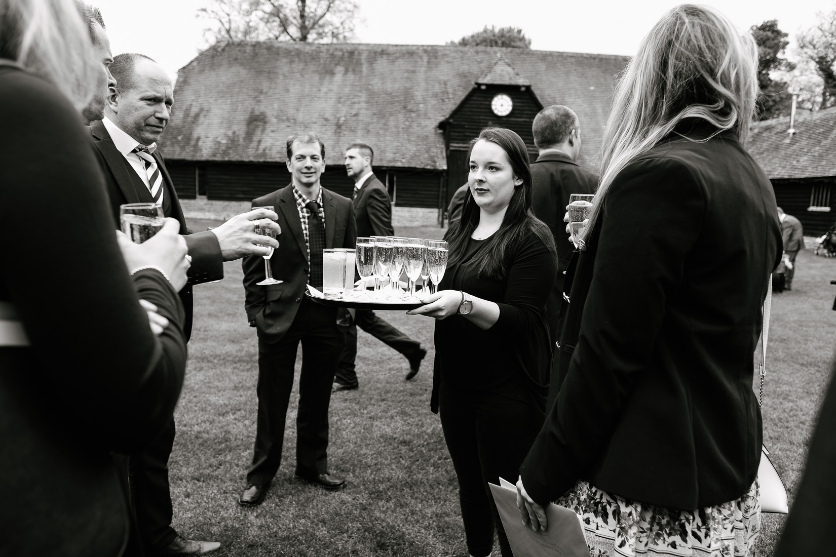 Guests being served drinks at Lains Barn Wedding Venue, Oxfordshire