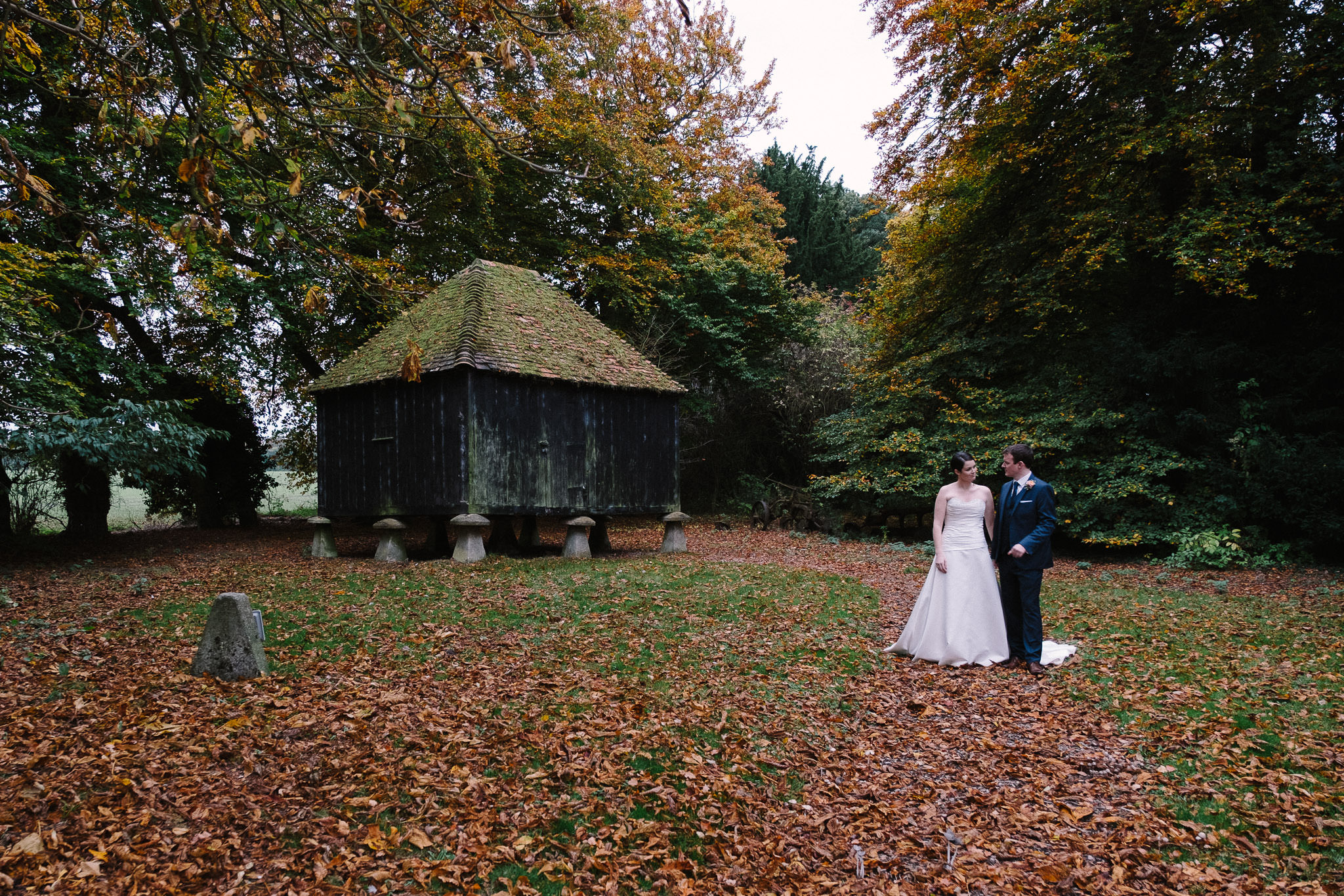 A bride and groom posing for a photo at Lains Barn wedding venue, Oxfordshire