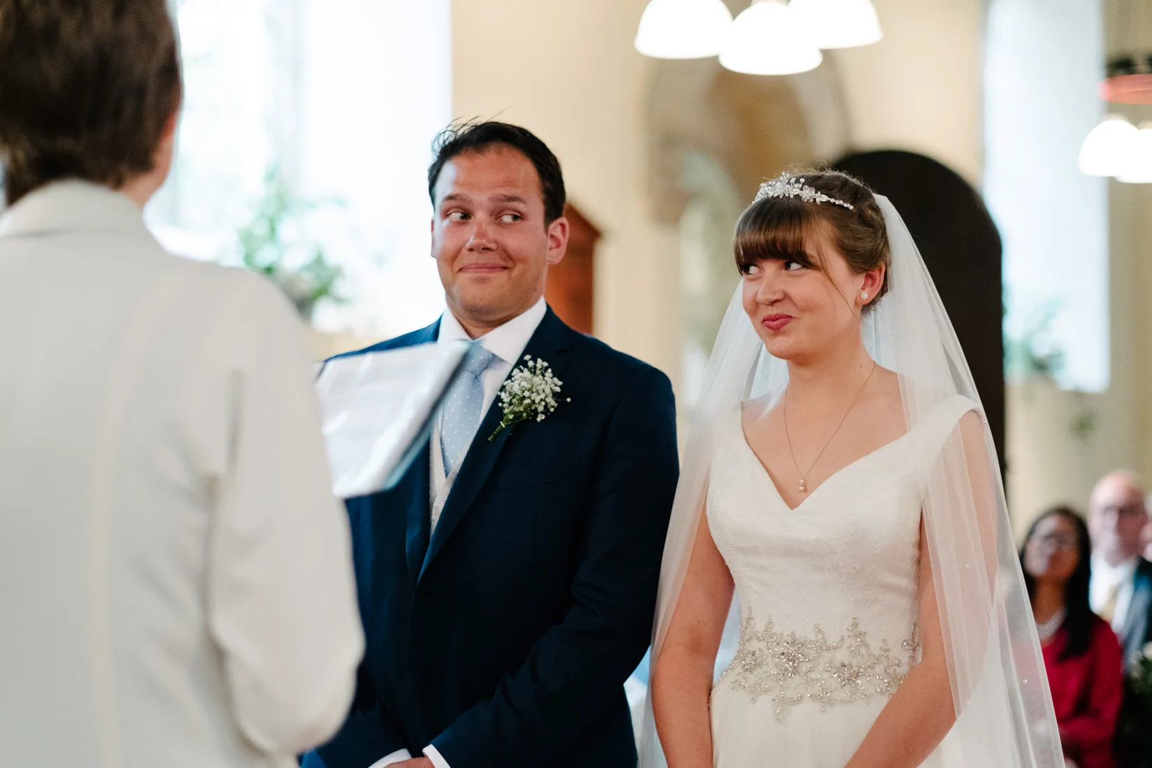 A bride and groom looking at each other in All Saints Church, Mixbury. By Sam and Steve Photography