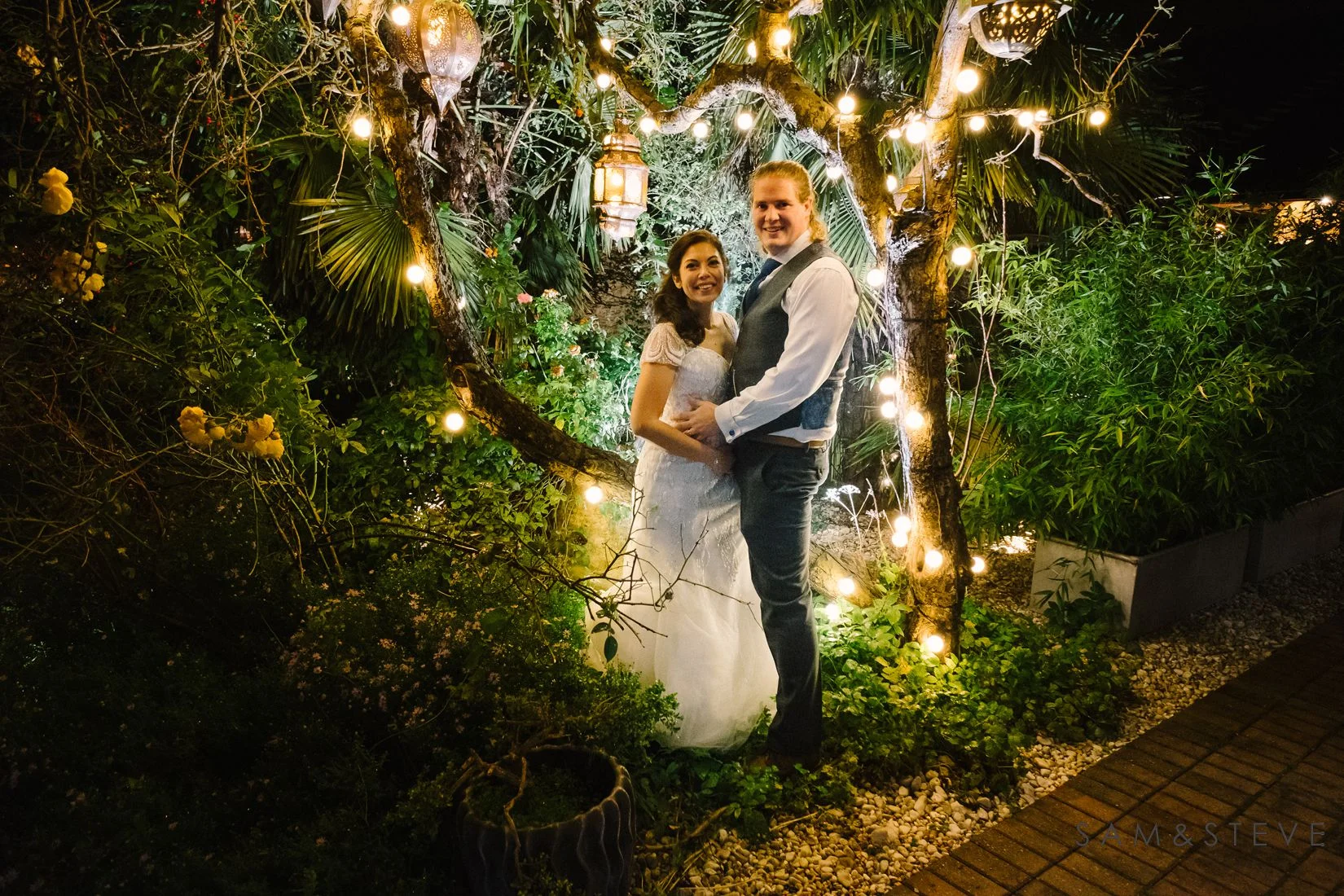 A bride and groom surrounded by fairylights at Crazy Bear, Stadhampton