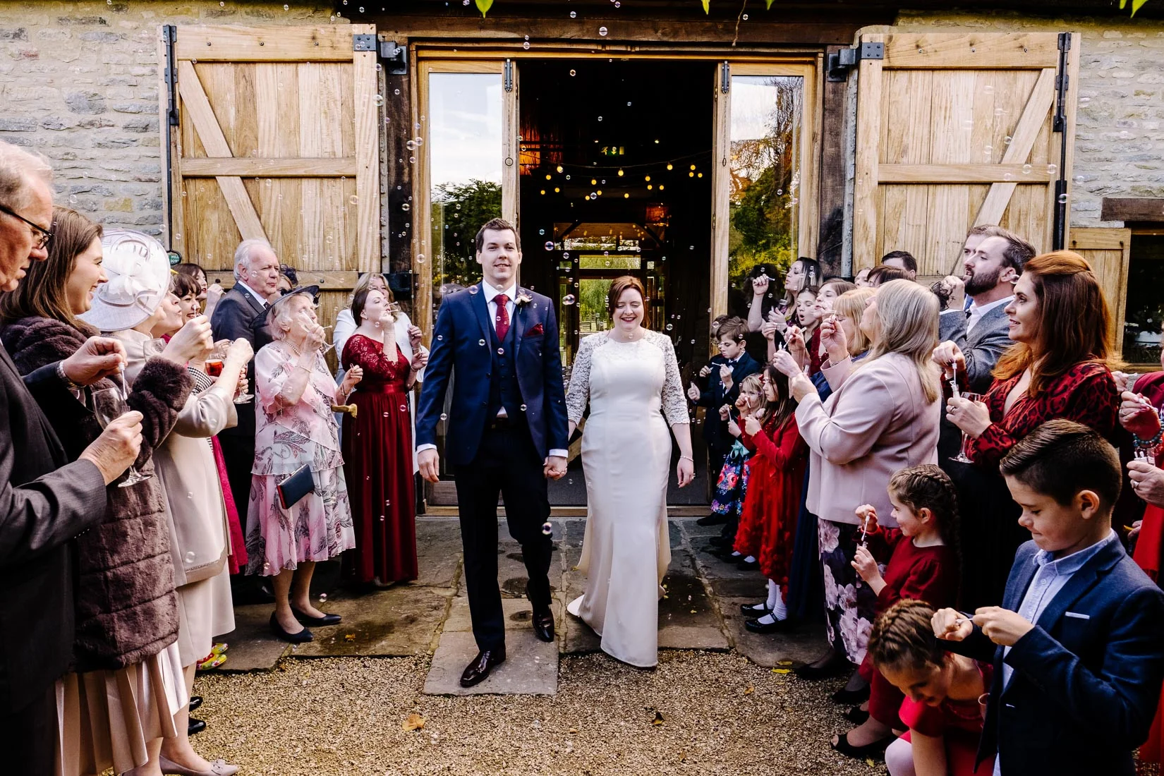 A bride and groom leaving their wedding at the Tythe Barn, Launton