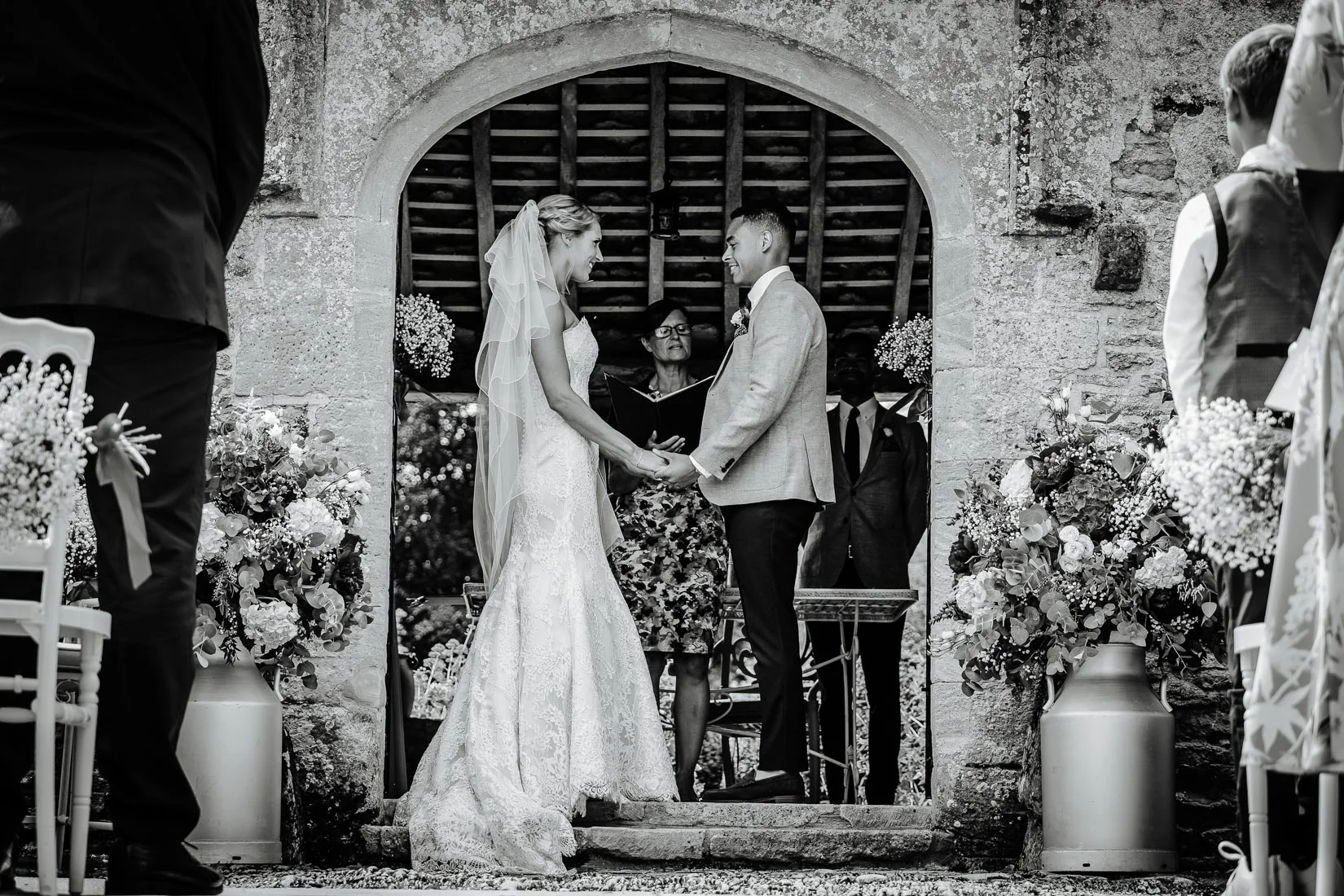 A bride and groom getting married outside at a wedding at Caswell House