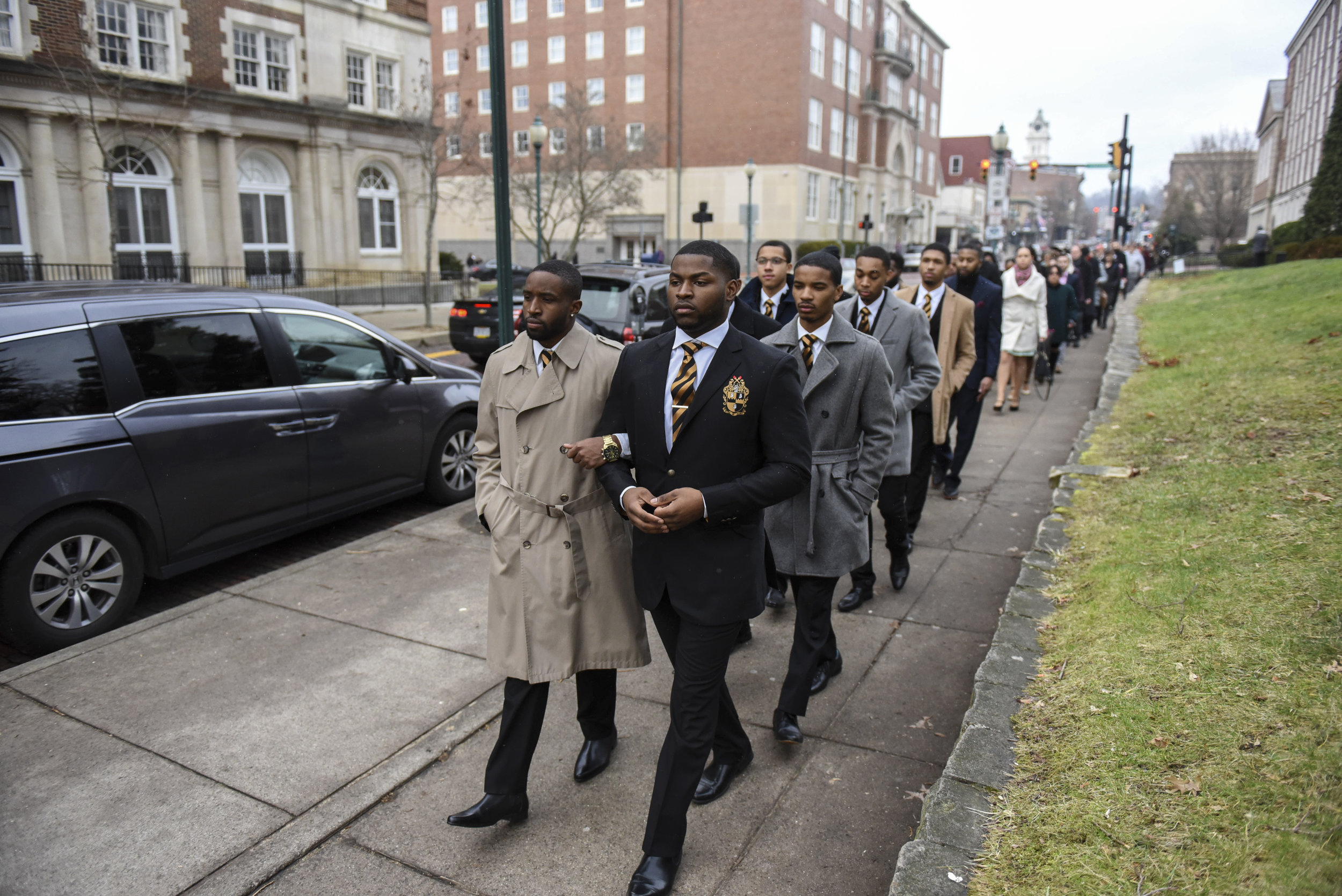 Elijah Cohen-Denison (left), Marquis Maines (right) and fellow members of Alpha Phi Alpha, a historically black fraternity at Ohio University, lead a silent march down Court Street in Athens, Ohio, in honor of Martin Luther King Jr. on Jan. 16, 2017. This is the 17th year that Alpha Phi Alpha has hosted this event.