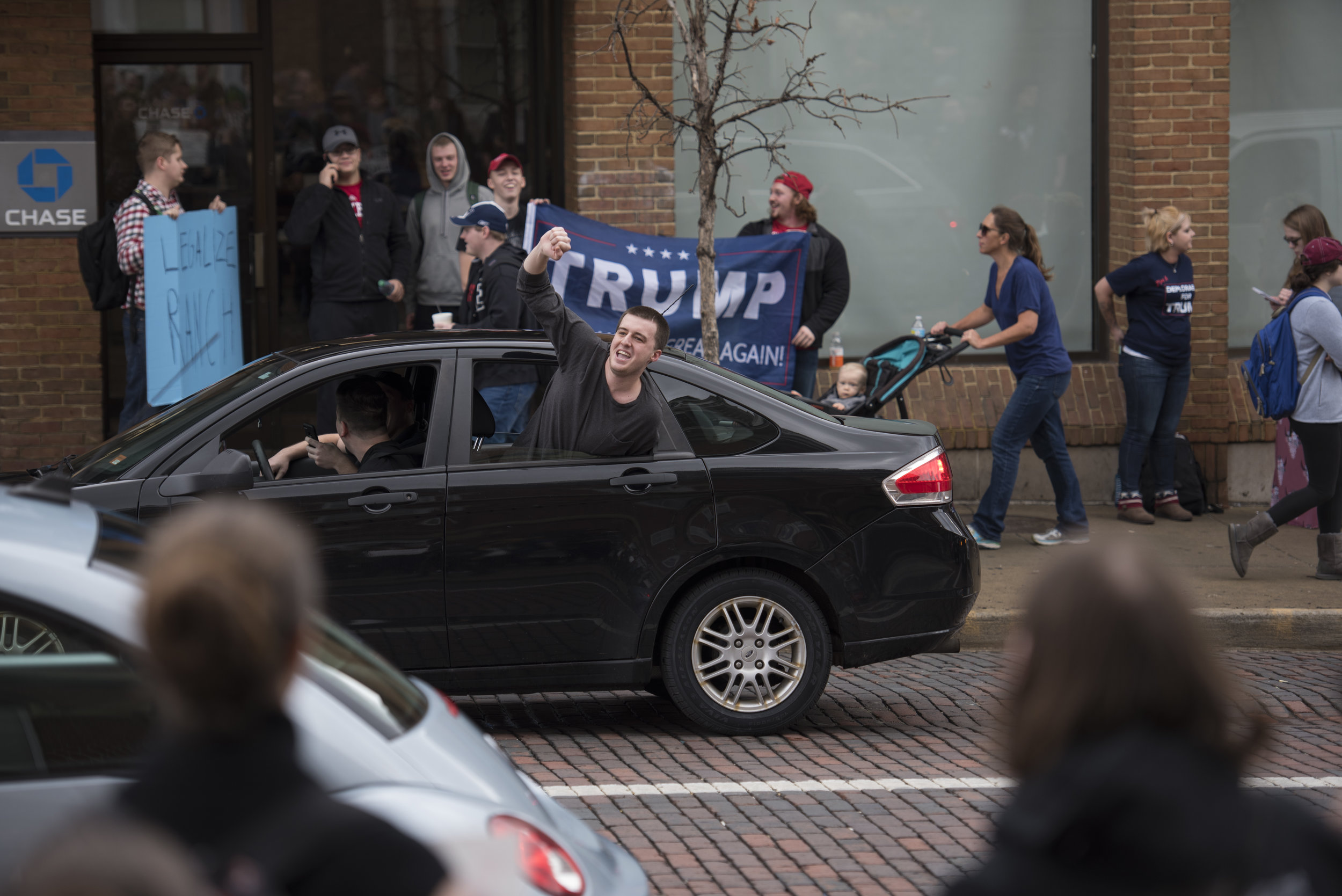 A Trump supporter yells out of a car window at a crowd of Trump protestors on Court Street on Jan. 20, 2017 in Athens, Ohio. The crowd had assembled in front of the courthouse after a walkout at Ohio University in protest of Donald Trump’s inauguration. Shortly after, a smaller crowd of Trump supporters gathered across the street.