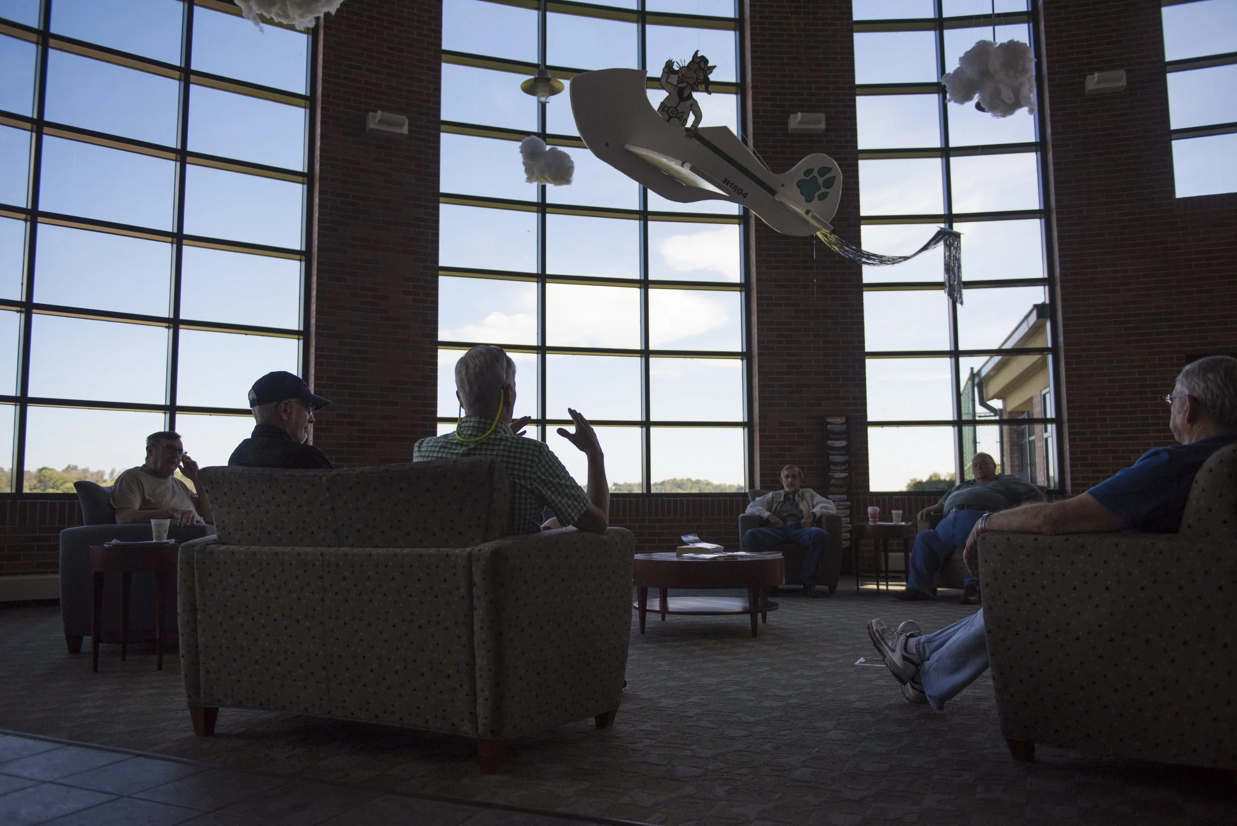 (From left to right) Rich Beckmell, Charlie Dorsey, Bryan Branham, Dave Weks, Phil Laughlin and Virgil Reeves sit in the terminal at Gordon K. Bush on Sept. 24, 2017. Every weekend they hang out, discuss flying and reminisce about the past while enjoying coffee and donuts.