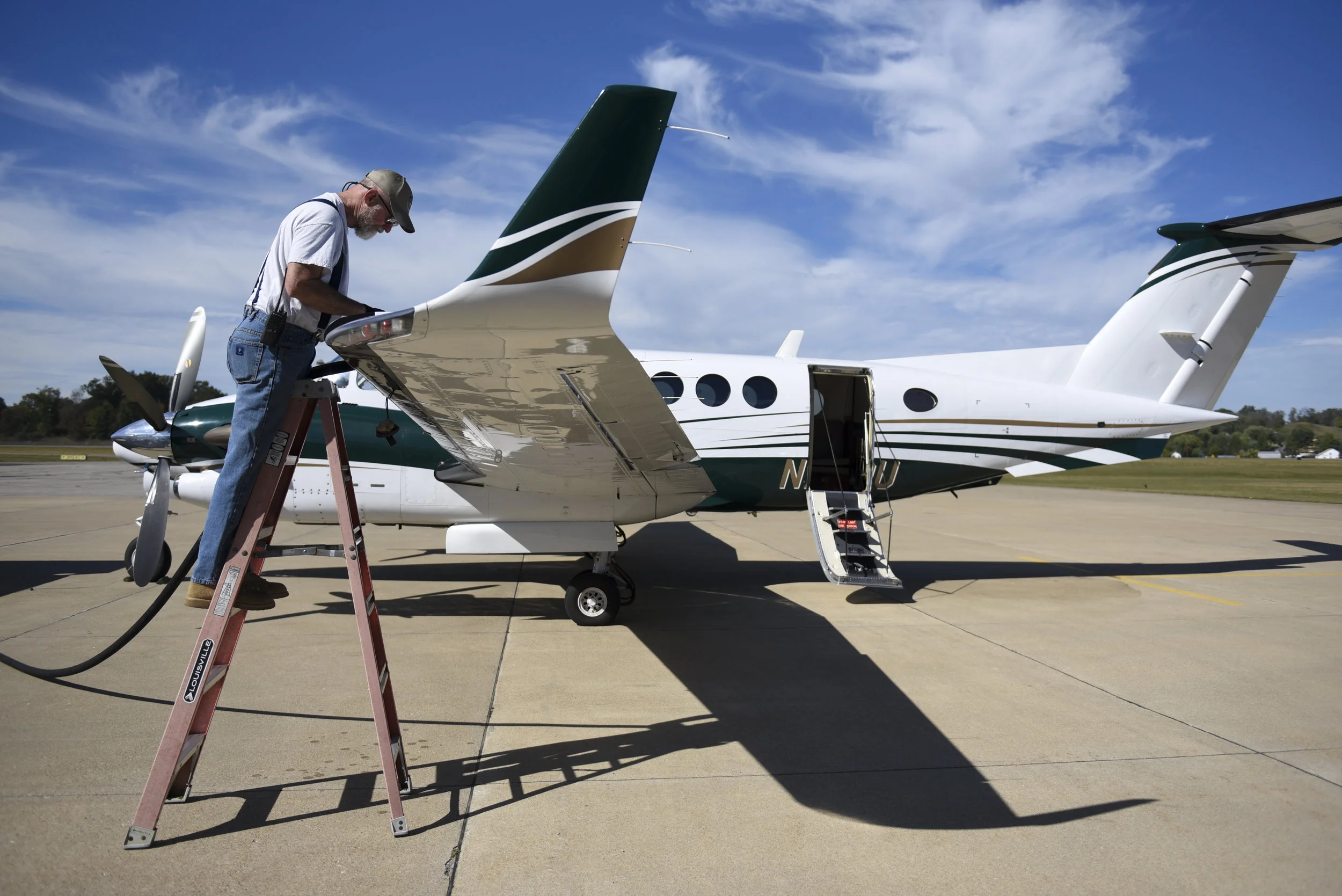 Bob Black fills the tank of the Ohio University King Air with fuel in preparation for university's trip to deliver donations to victims of hurricanes in Puerto Rico.