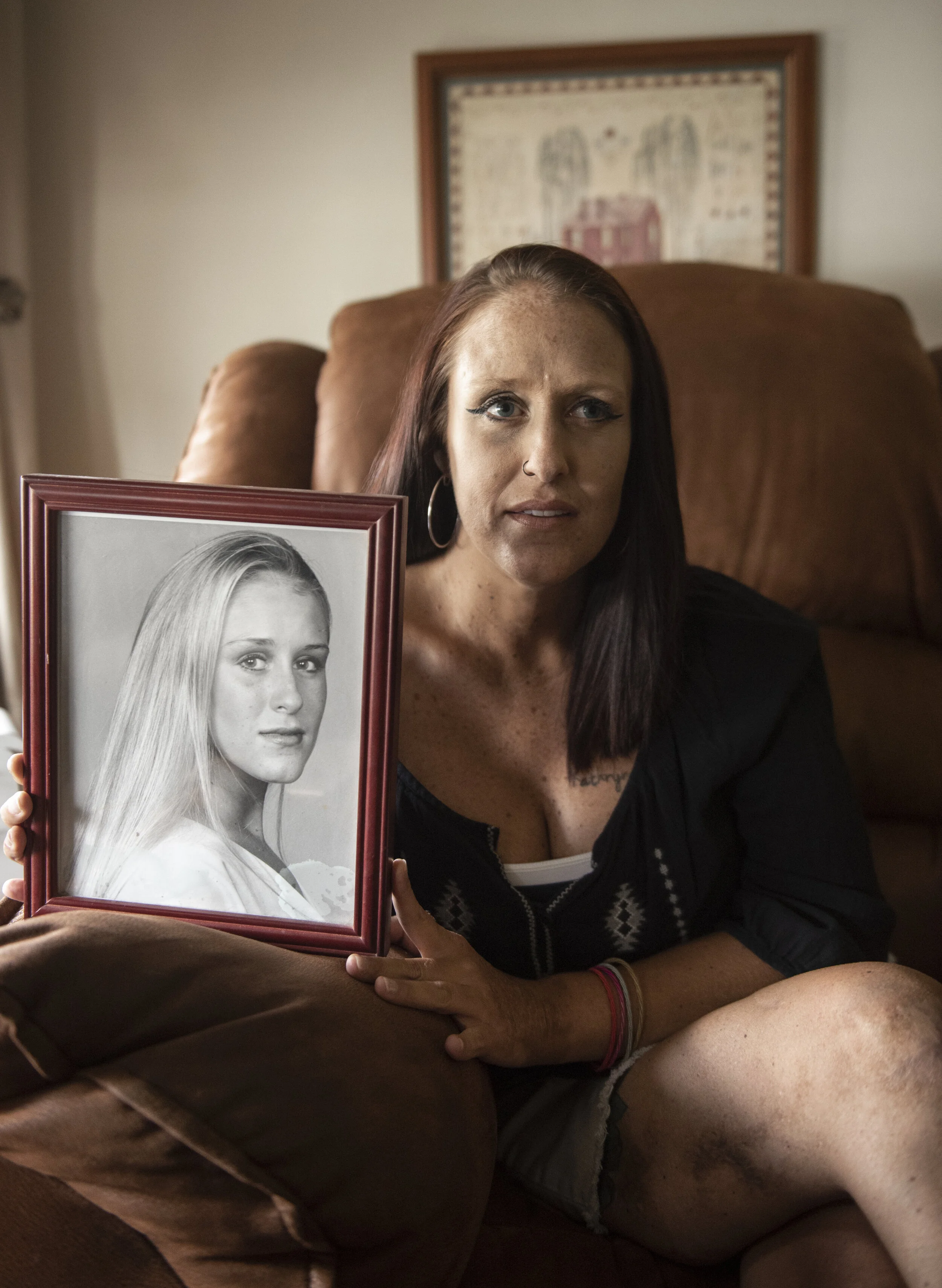  Erin Campbell poses with a portrait of herself taken in 1998 for a modeling shoot that she says reminds her of a time when she knew something was going wrong in her life. Campbell suffered a stroke during surgery that left her blind following a suic