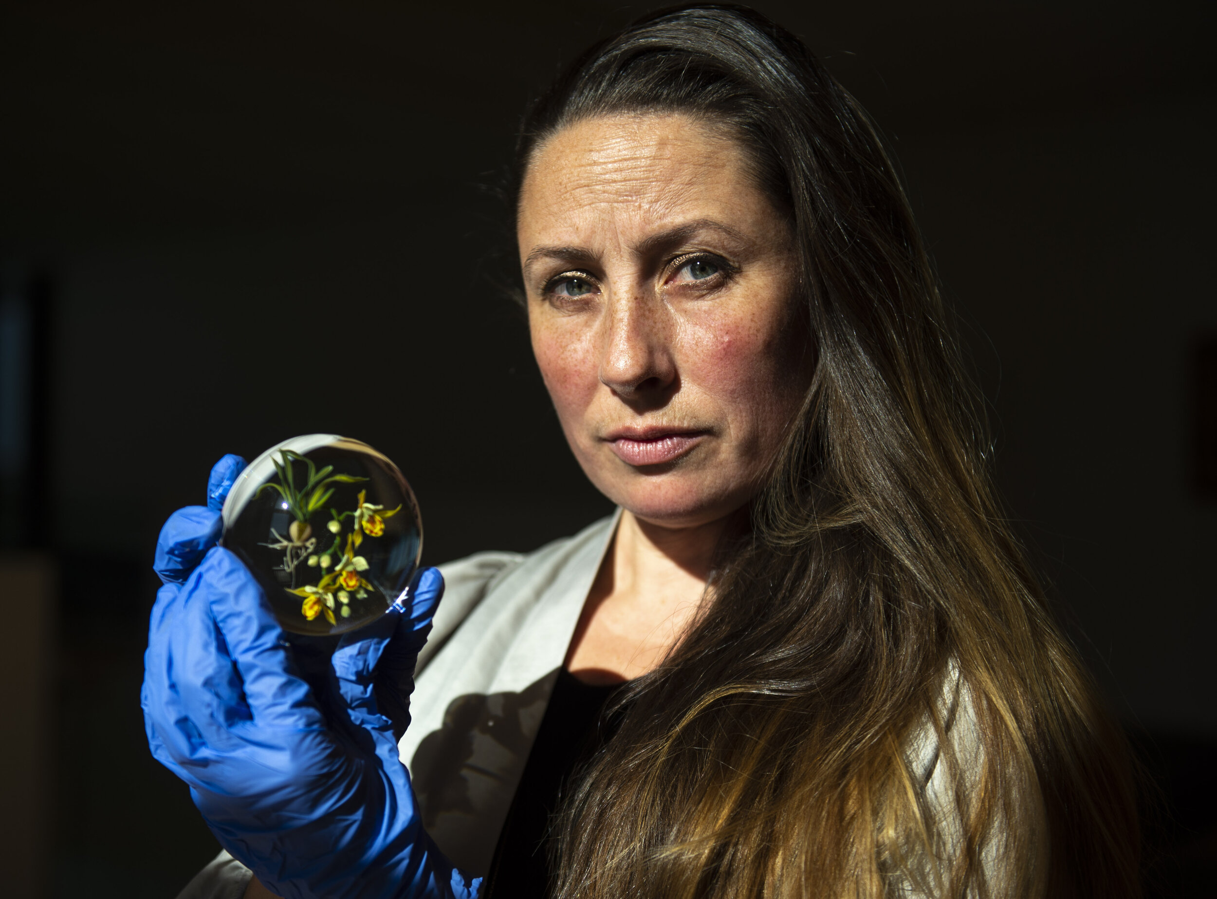  Barry Art Museum Interim Director Charlotte Potter Kasic poses for a portrait with Paul Stankard's "Caladenia Orchid", one of the pieces that will be displayed in the upcoming exhibit Orchids: Attraction and Deception, at Barry Art Museum on Old Dom