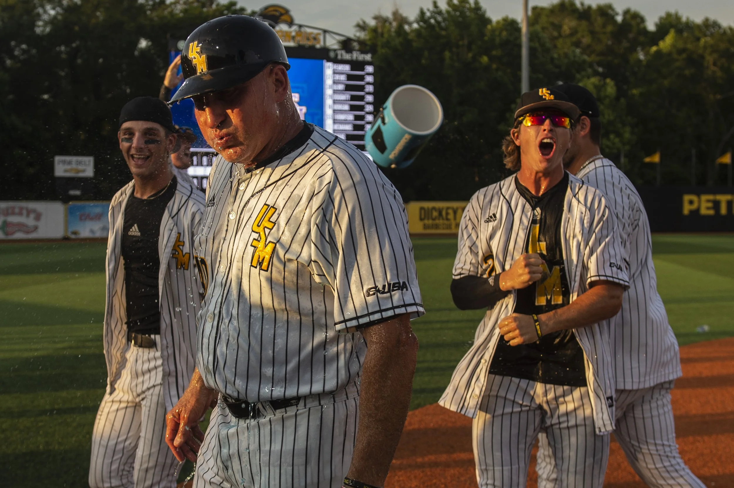  Southern Miss players dump a gatorade cooler on Coach Berry after defeating LSU 8-7 in the NCAA Regionals at Pete Taylor Park in Hattiesburg on Monday, June 6, 2022. 