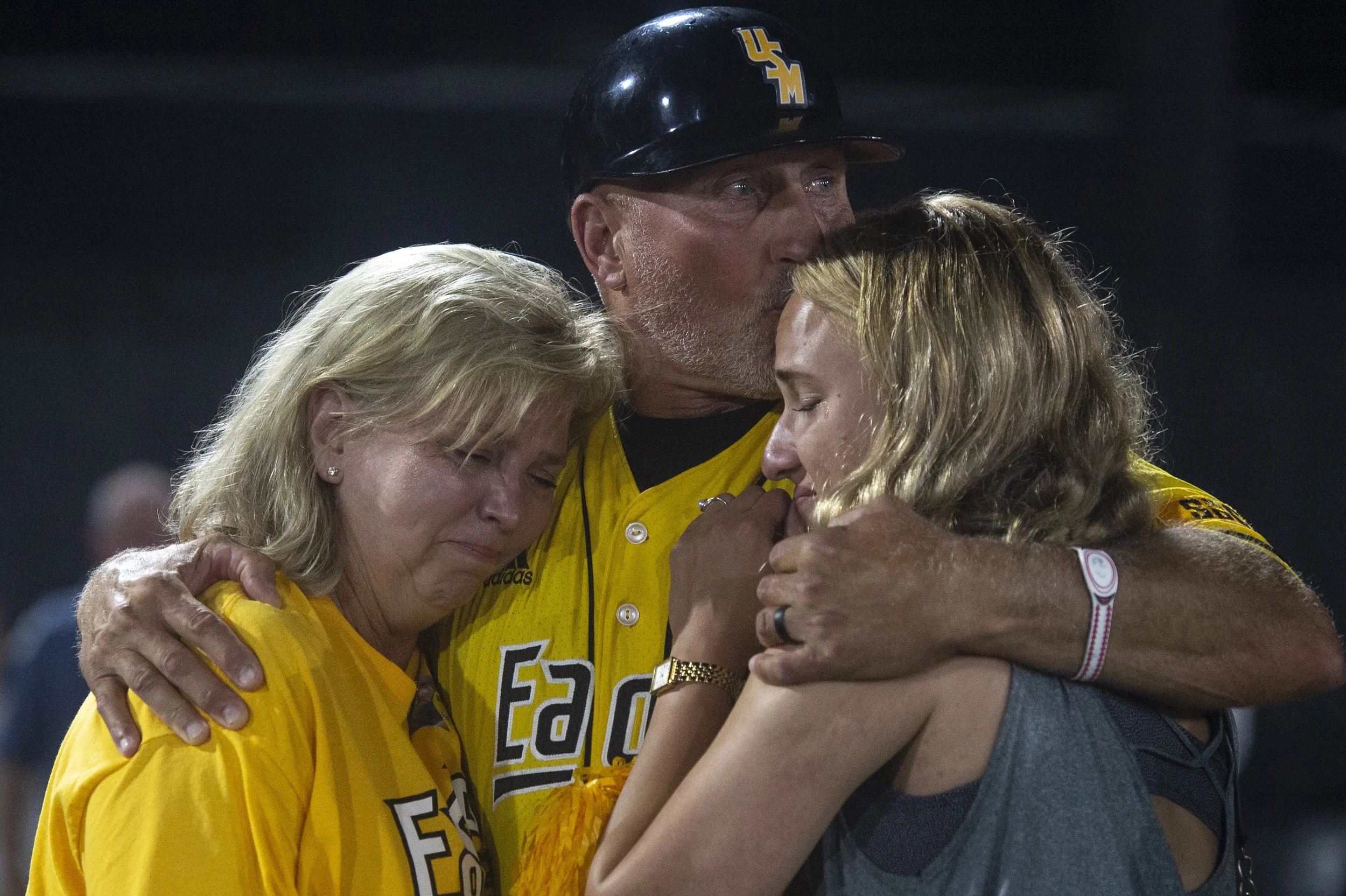  Southern Miss Head Coach Scott Berry hugs his family after Southern Miss lost to Tennessee in the NCAA Super Regional at Pete Taylor Park in Hattiesburg on Monday, June 12, 2023. Berry is retiring after the season. 
