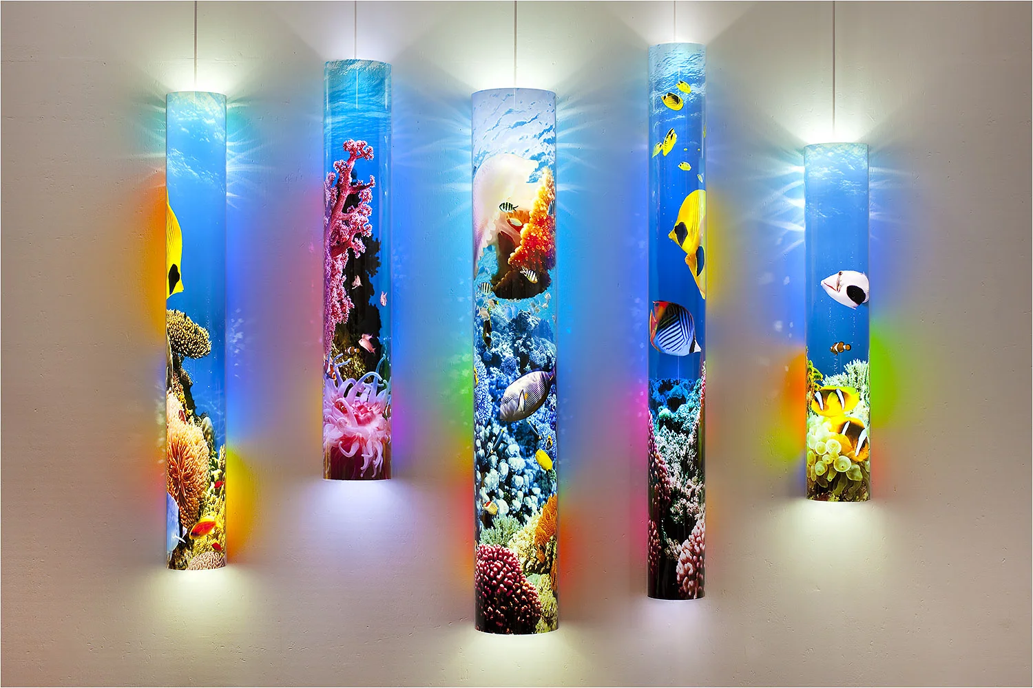 An LED light mural titled Tube Aura with a coral reef theme. Archival pigmented ink on backlight media inside cast acrylic tubes. Digital art photo collage by Les Seymour.