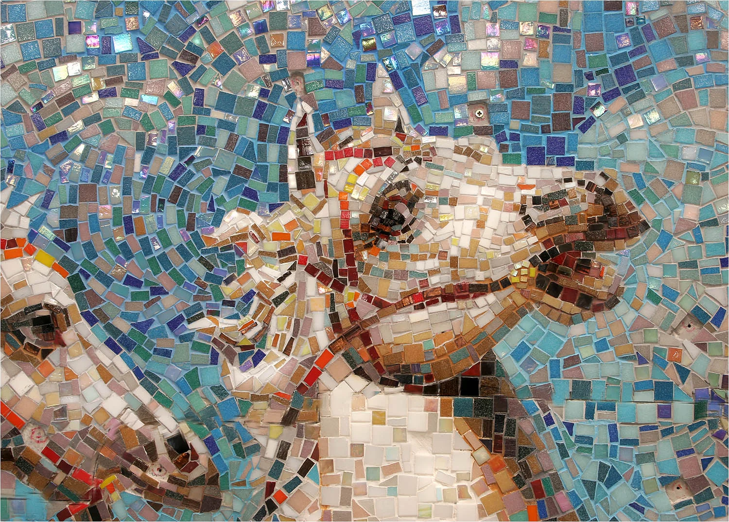 Detail from mosaic mural in vitreous glass tile. Mosaic murals can be made with ceramic hot fire tile or Smalti glass tile.