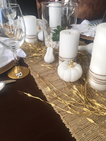 Table runner World Market // Gold garland Hobby Lobby // Faux pumpkins and squash Hobby Lobby (painted with acrylic paint) // Candles from our wedding (I have SO many) I just super glued twine on to them // twine Michaels // Large glass holders Hobby Lobby // Faux succulents Hobby Lobby // white rock in glass jars Dollar Tree