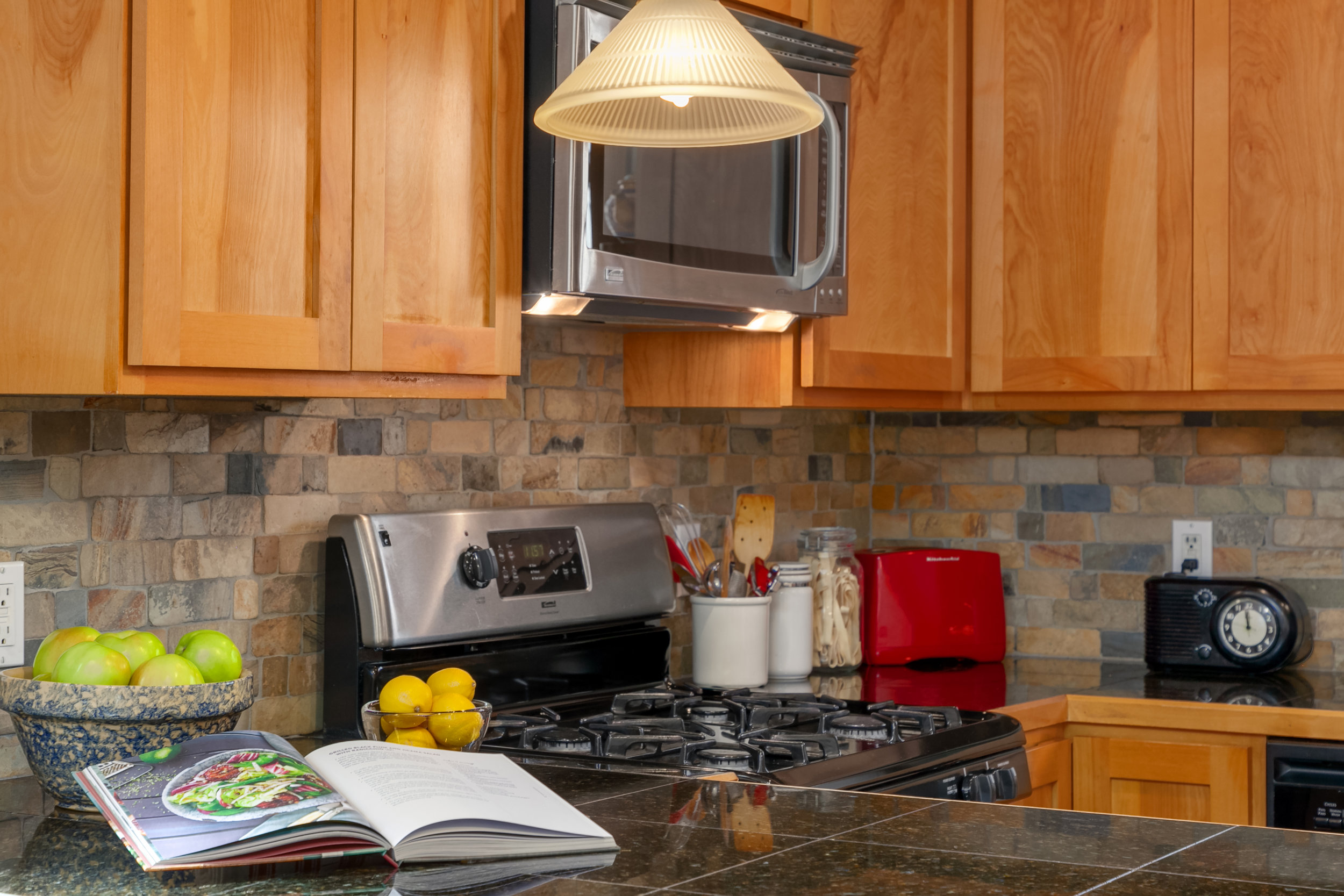 Granite counters, slate backsplash, hardwood cabinetry.