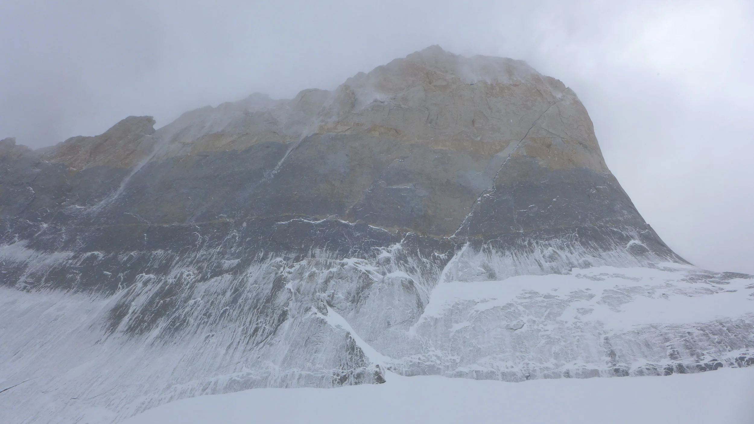 The base of the South Tower plastered in snow.