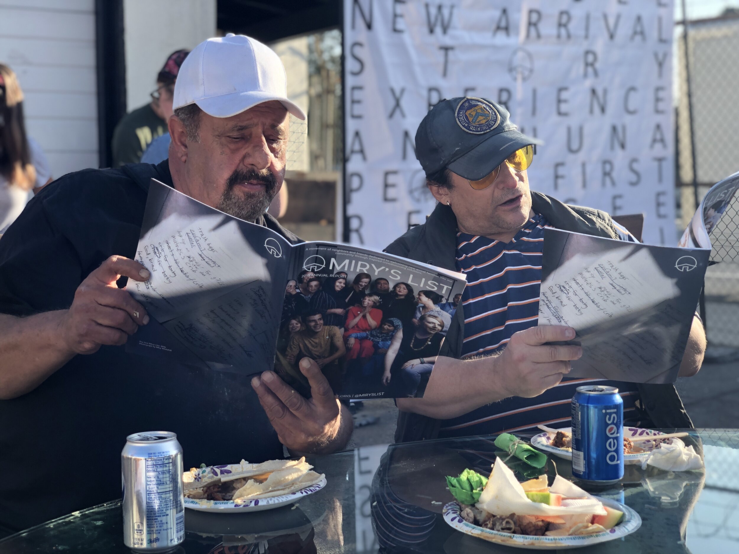  Neighbors gather at LA Road to share a meal with their resettling neighbors in July 2019 