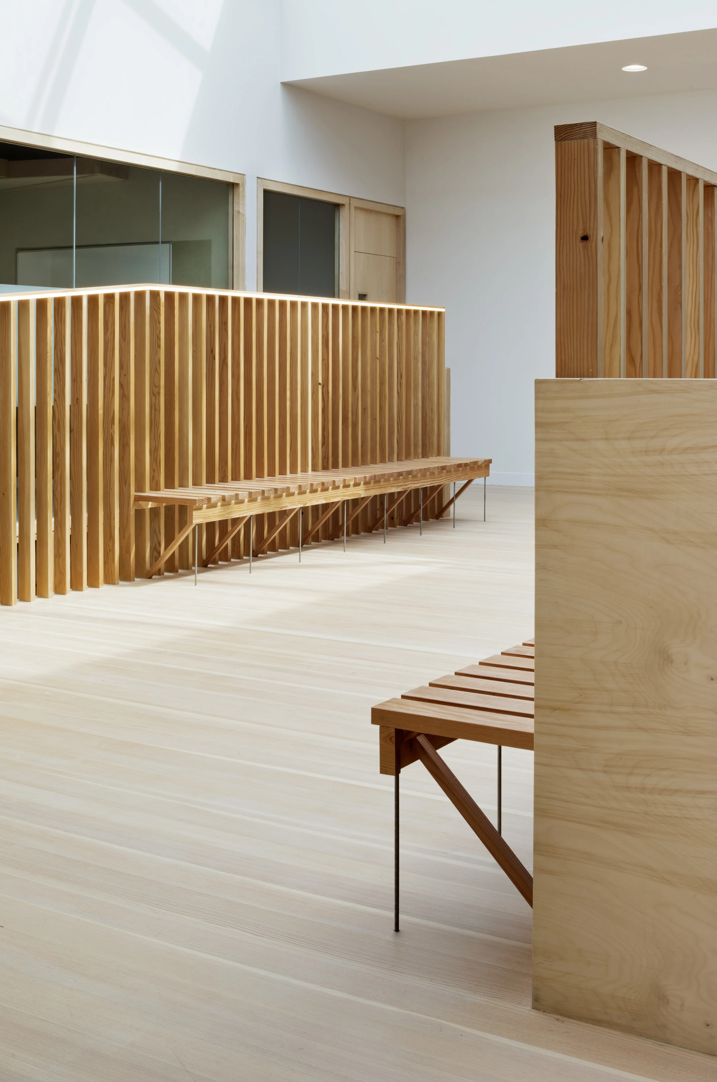 Fig. 5 Waiting and circulation space between offices and meeting rooms, cedar handrail and bench, douglas fir floor, kerto handrail beam