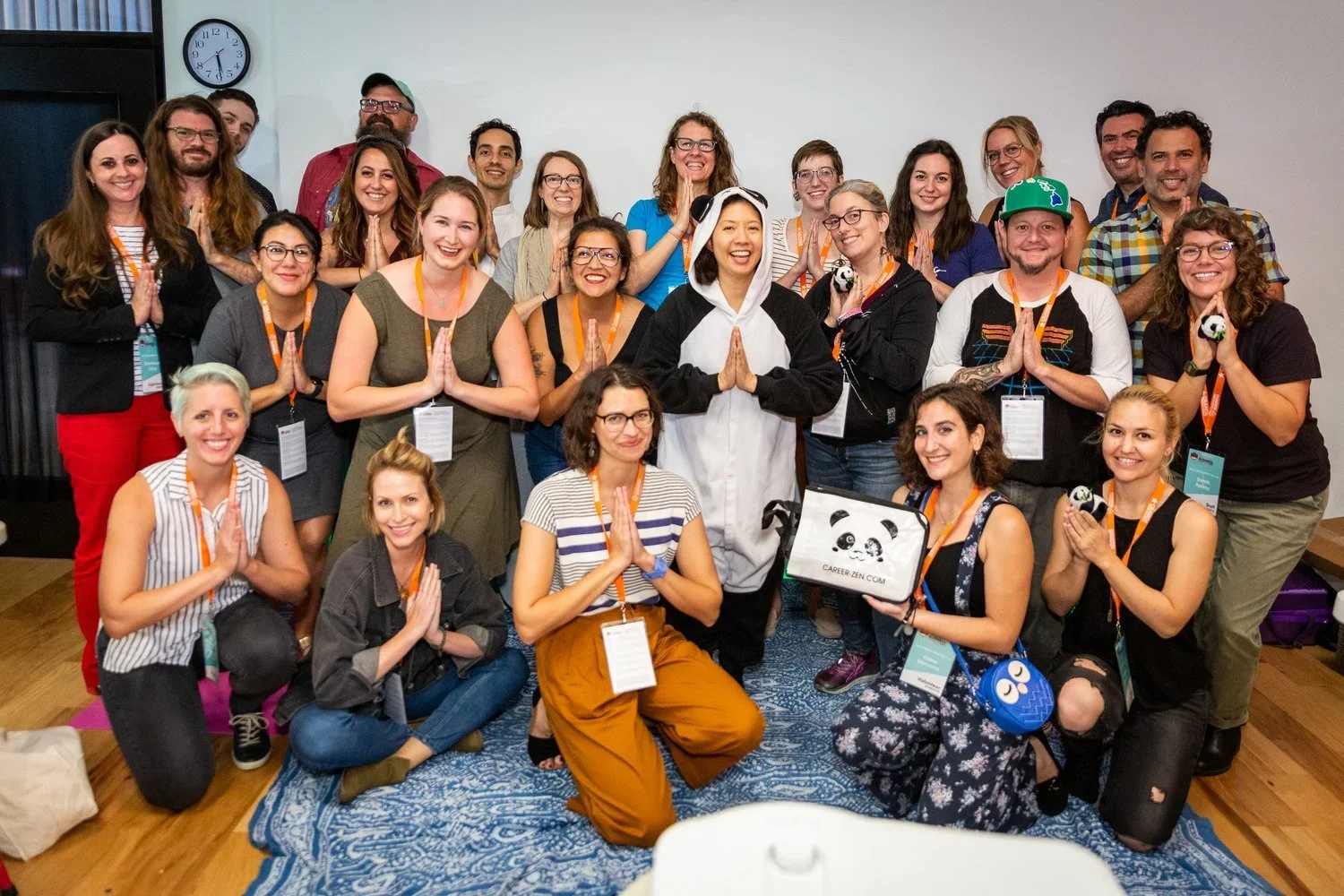 Dr Lynn Chang of Career Zen with a large group of smiling faces during a work presentation
