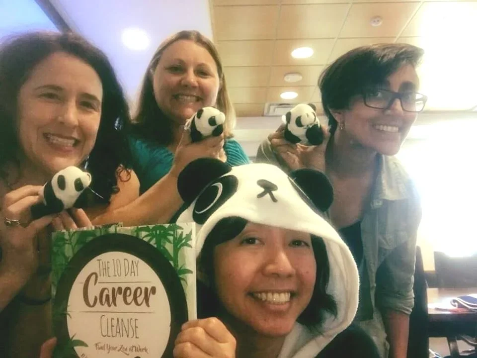 Dr Lynn Chang at a university presentation holding up the book 10 Day Career Cleanse and participants holding a panda toy
