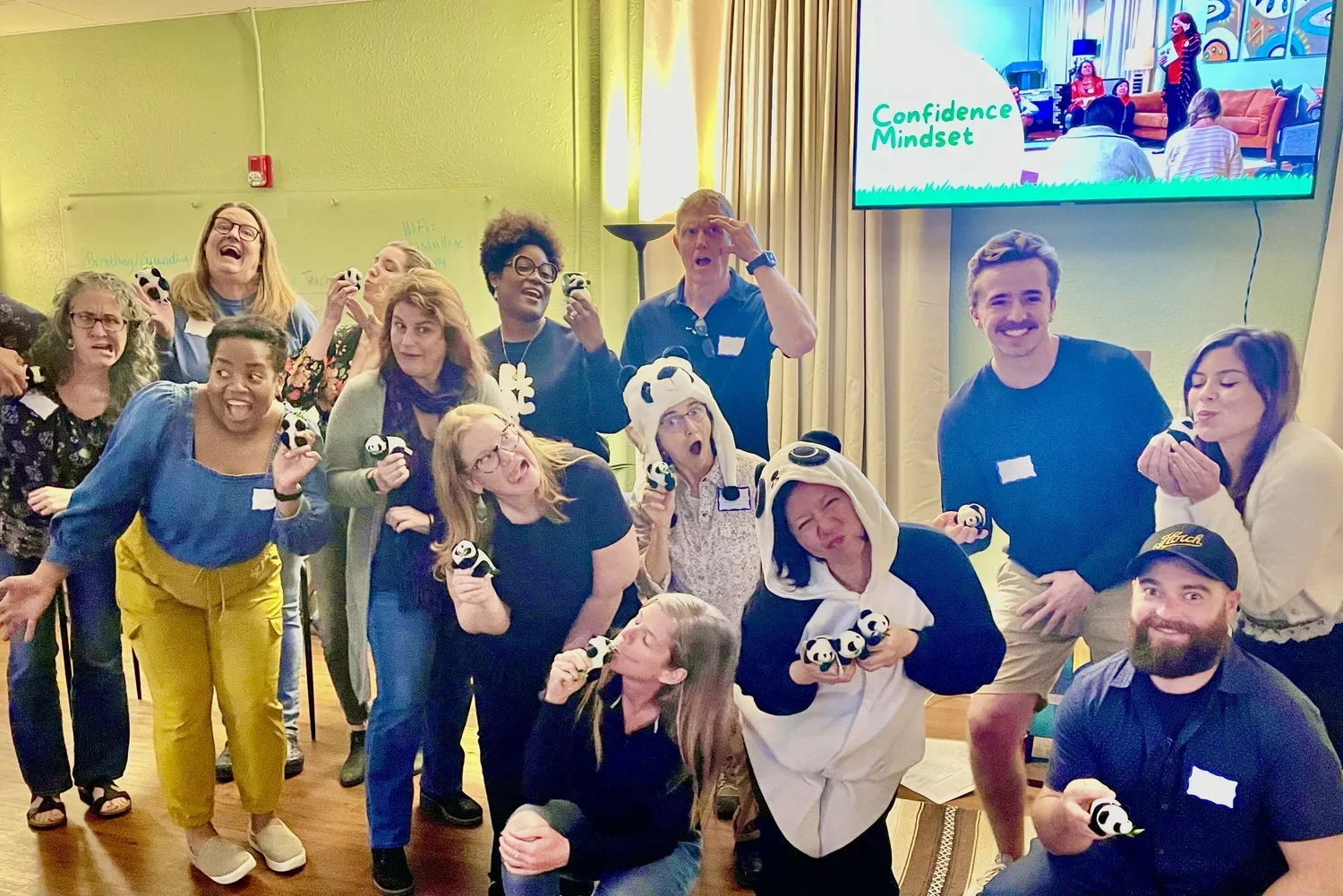 Dr Lynn Chang with students and colleagues being silly with panda toys