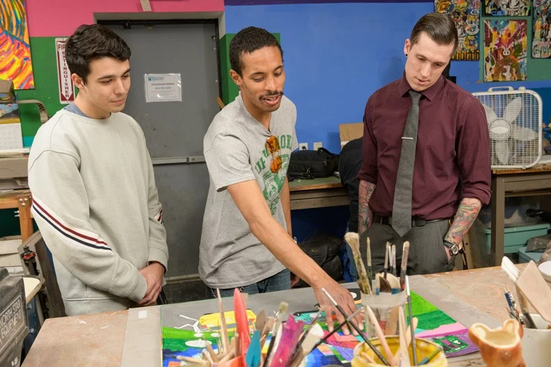 In the Creative Vision Factory’s open work space (from left), UD undergraduate Dillon DiGuglielmo, artist Geraldo Gonzalez and graduate student Joshua Stout look over some of Gonzalez’s work. Gonzalez, whose artwork has a transportation theme, was also enrolled as a student in the class.