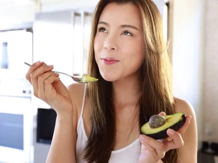 Model eating avocado