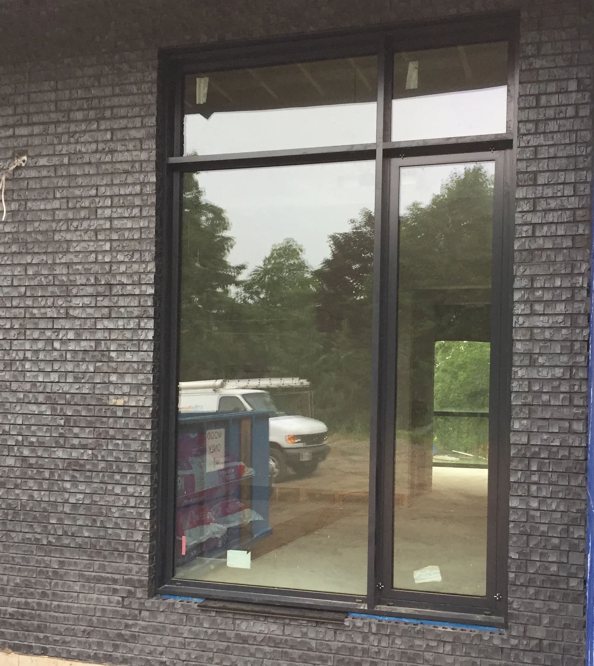 Combination fixed with tilt & turn window with transoms above.