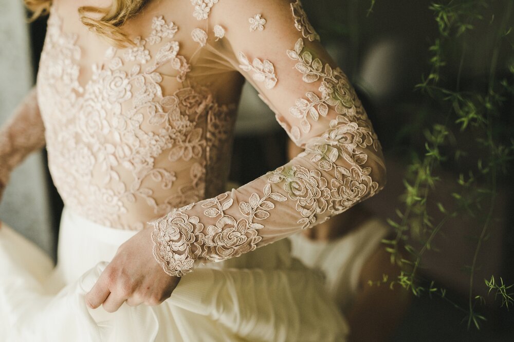 Lace details on blush wedding dress