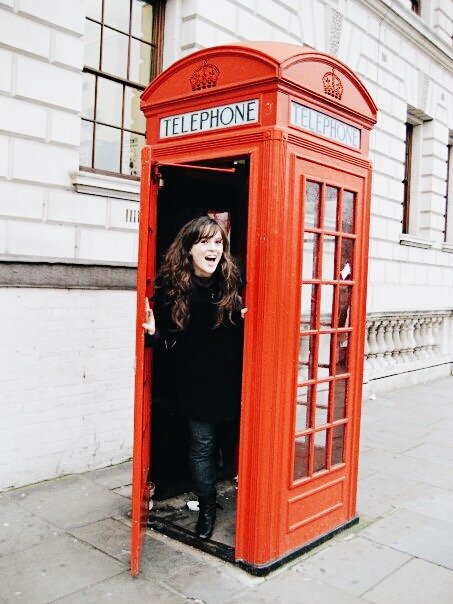 tourist in a red phonebooth London, England