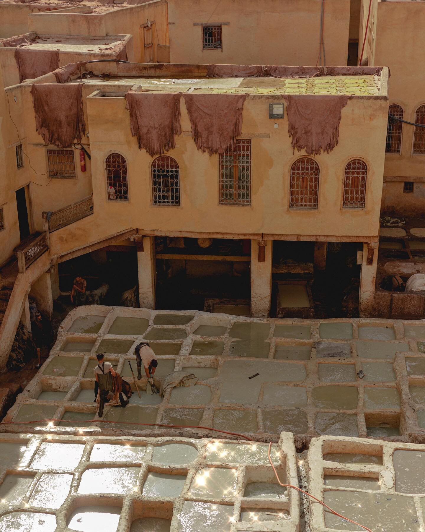 the tannery. the largest and one of the oldest in the city of fez, morocco. the animal hides are processed by first soaking in these stone vats that are mixed with (it&rsquo;s not pretty) pigeon feces, among other things, to clean and soften the skin