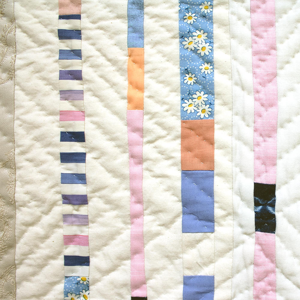 Detail view of Portals for Kevin 3: Portal for Nex. Reclaimed garments and other cotton fabrics, machine pieced, hand quilted. 34.5x34.5 inches, 2024