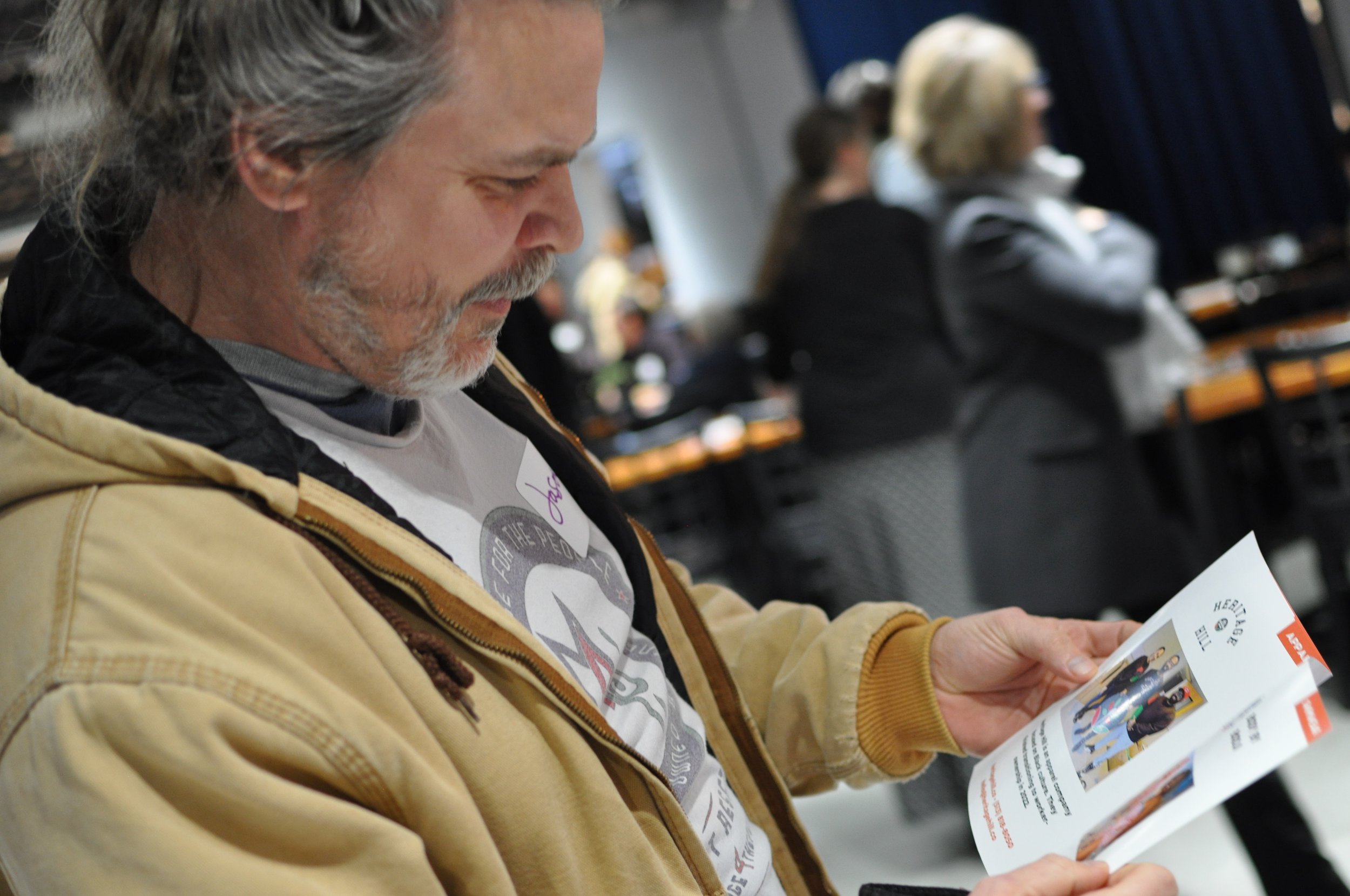 Reading a brochure at at Co-op Cincy's 2022 annual dinner.JPG