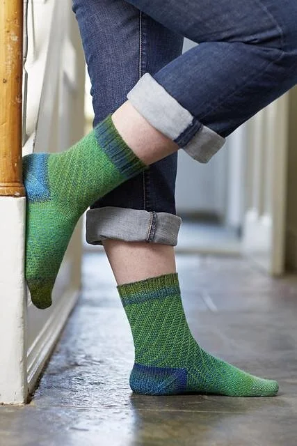 The Cutcombe Socks — fun spirals that would love to be worked up in a Schoppel Zauberball and Socks Yeah! 4ply. Find pattern and yarn in our Stepping Out collection in the online shop.