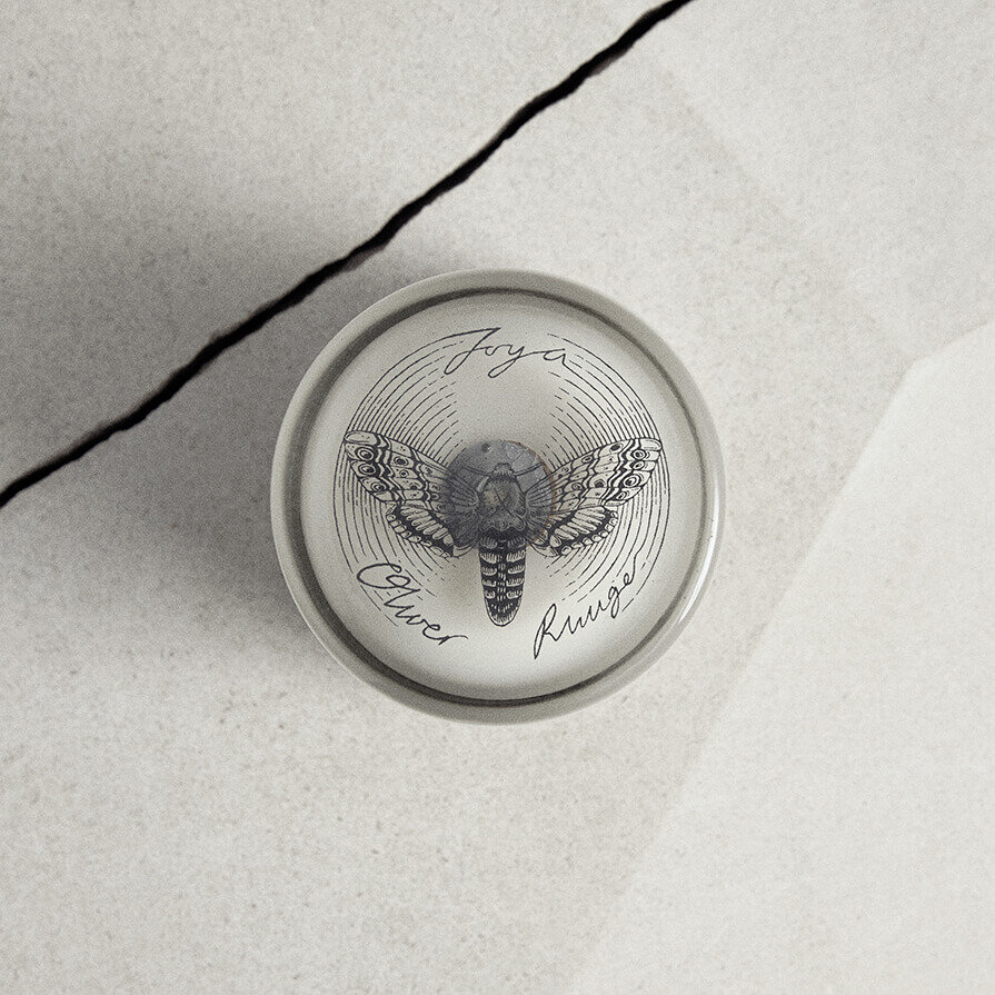 Oliver Ruuger candle shot from above. Resting on stone work with crack.