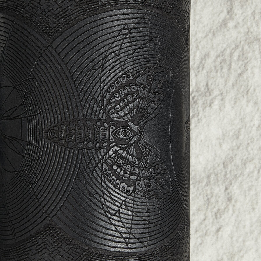 Oliver Ruuger candle, close up of etching on leather cover.