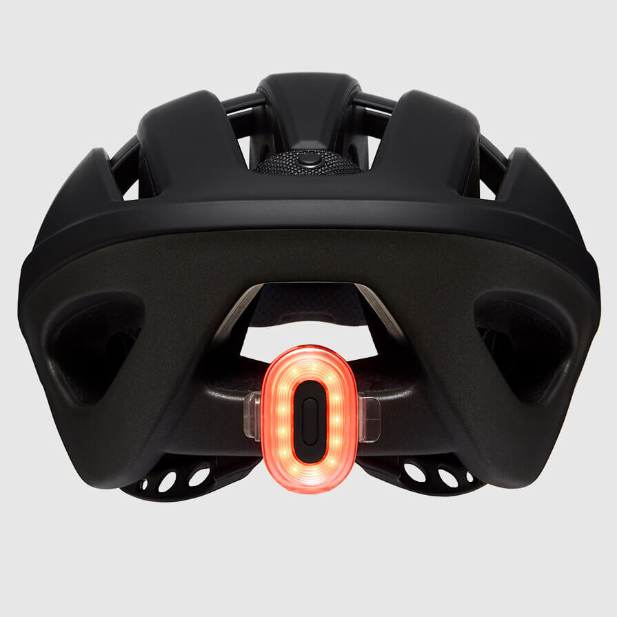 Rear Pixel Beryl bike light attached to the back of a black helmet. Ecommerce product.