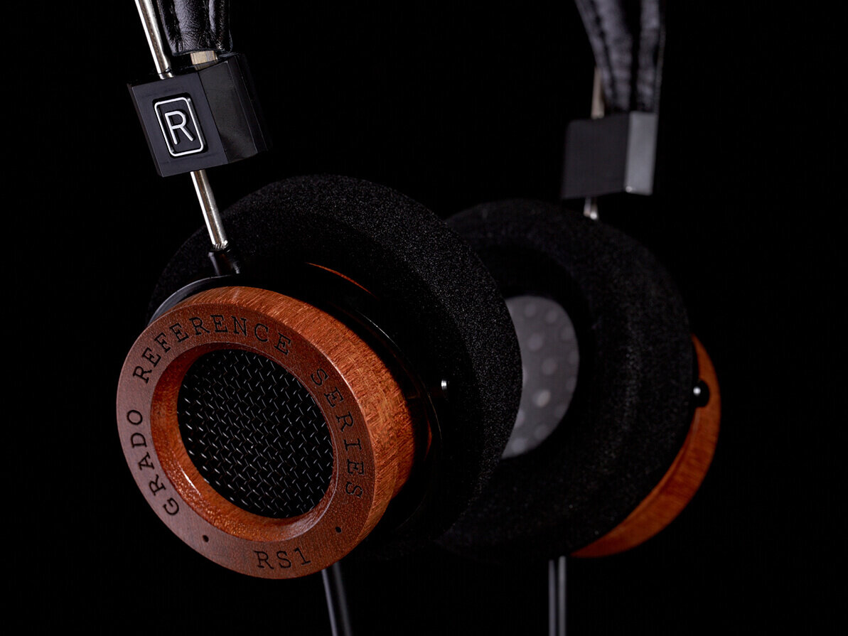 Close up wooden and foam headphones. Black background.