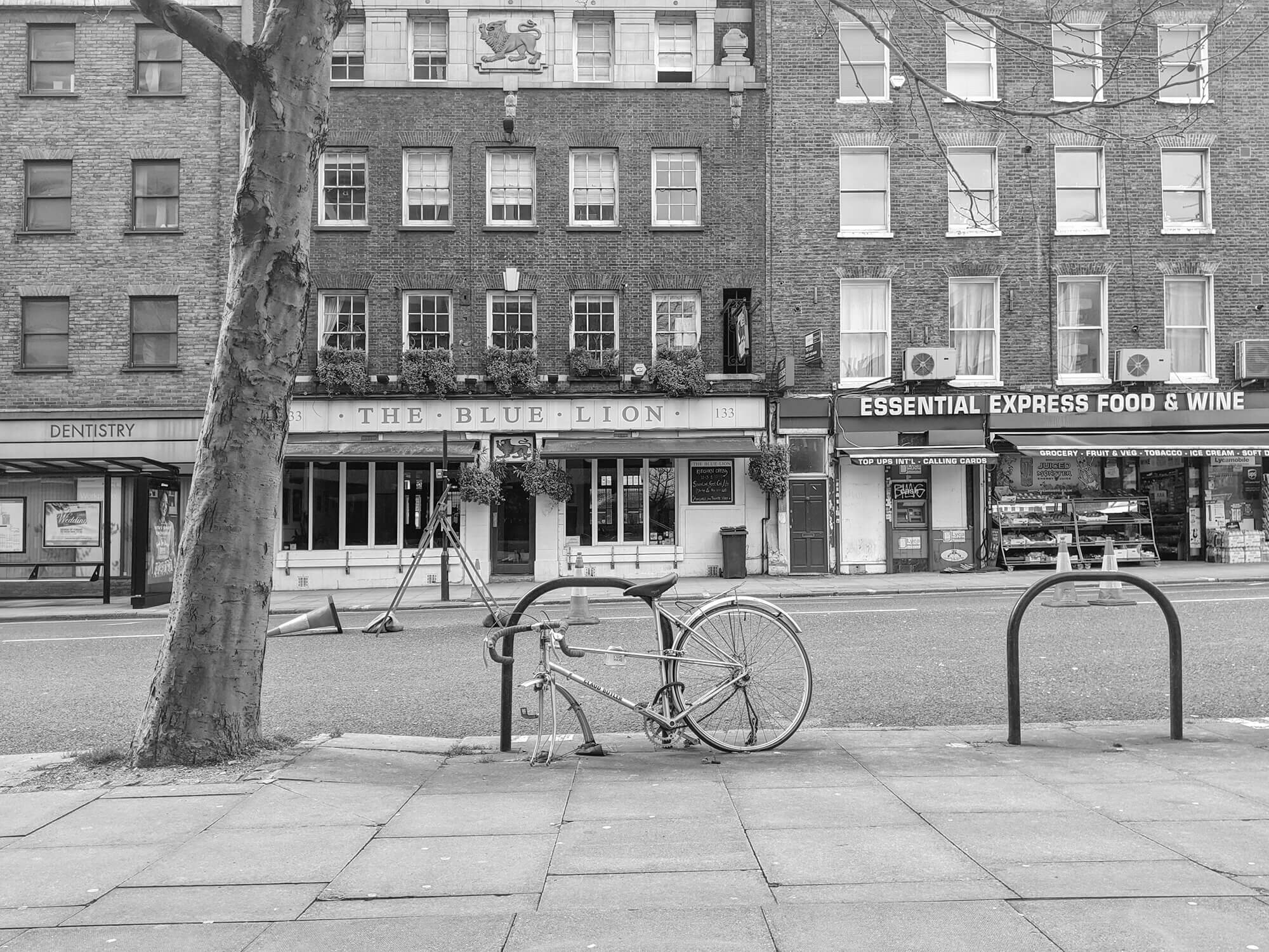 Womens town bike missing front wheel. Black and white cycling photograph.