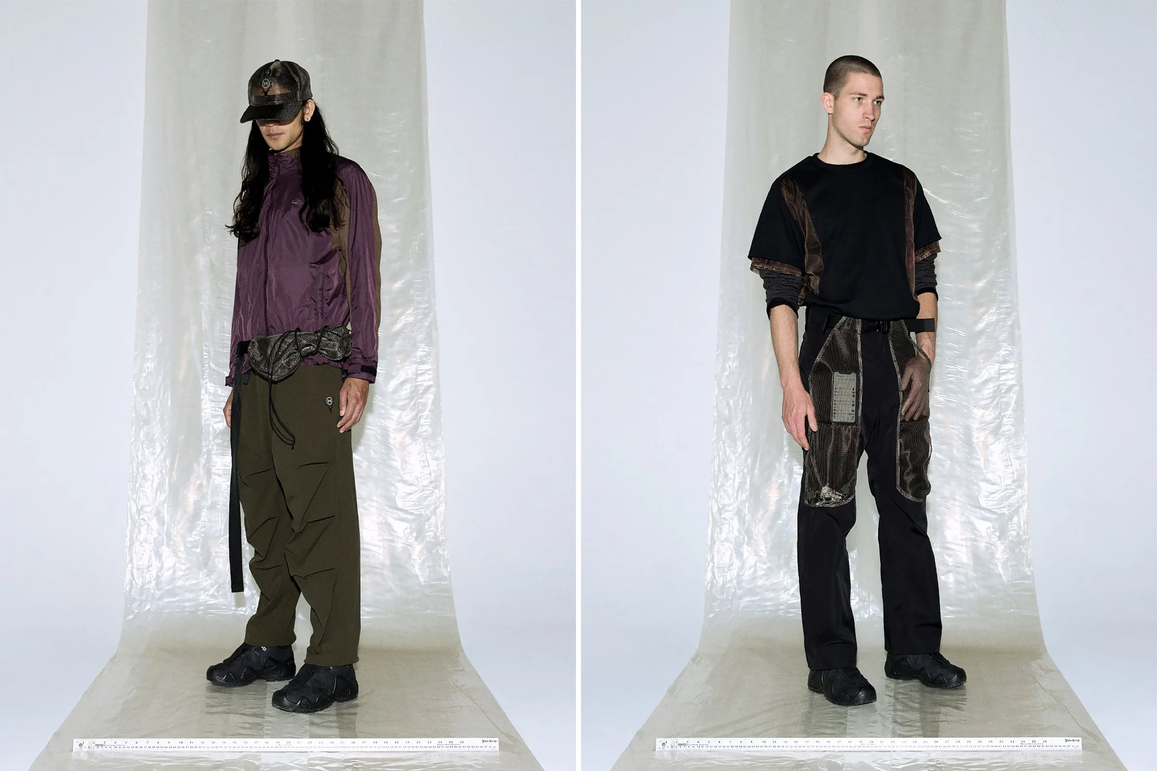 two male models stood on white background with cling film backing.