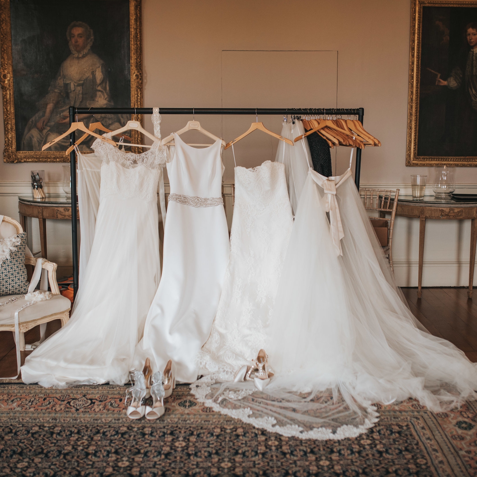 Beautiful Satin Wedding dresses laid out ready to put on draped over the back of a chair