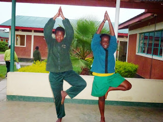 Ann Sammy is on the left doing Tree Posture