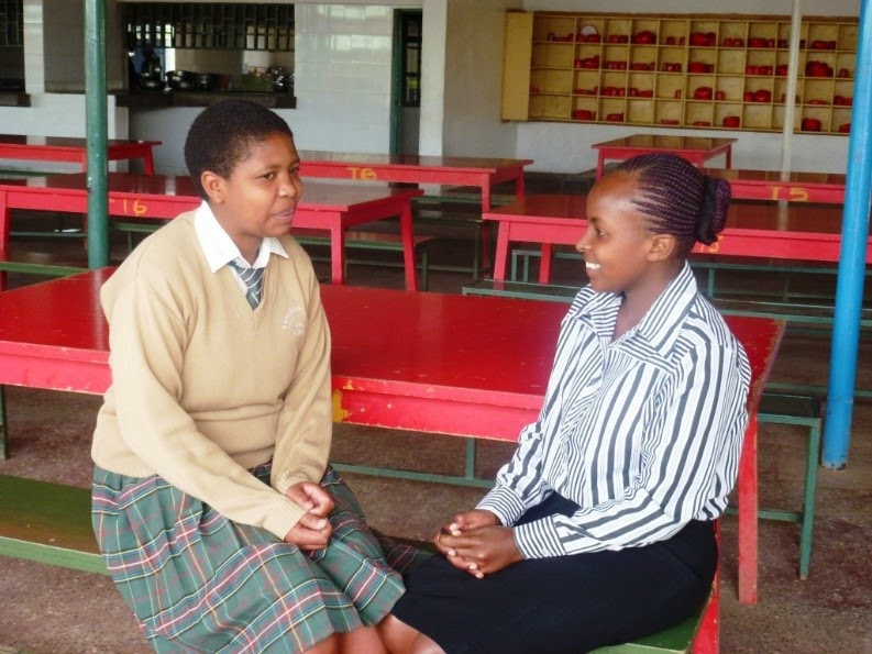 Esther Wagaki sharing a word of advice to Valentine Ngigi, an EFAC Scholar at Vanessa Grant Girls School.