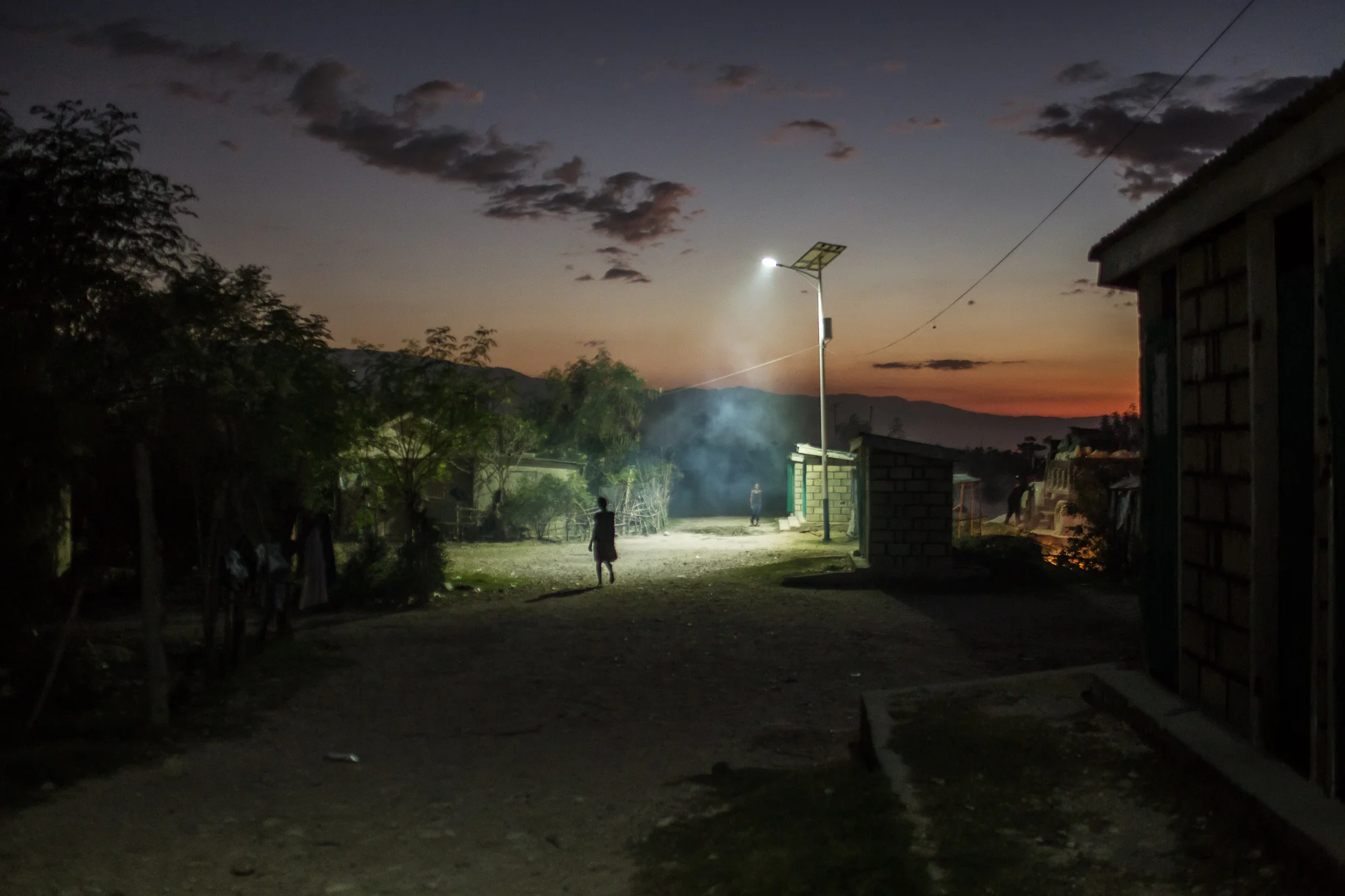 A solar-powered street light illuminates the Corail-Cesselesse camp for people displaced by the 2010 earthquake on Saturday, December 20, 2014 in Port-au-Prince, Haiti. The batteries for the lights are wearing out, and many do not last for more than a few hours. The camp is home to tens of thousands of people, for most of whom there is no work or easy access to the center of town, some 18 kilometers away.