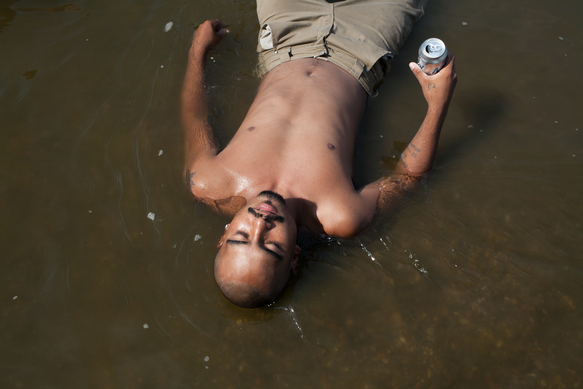  Alazar "Junior" Soto lies in the Des Moines River while tubing on Sunday, July 15, 2012 in Lehigh, IA. 