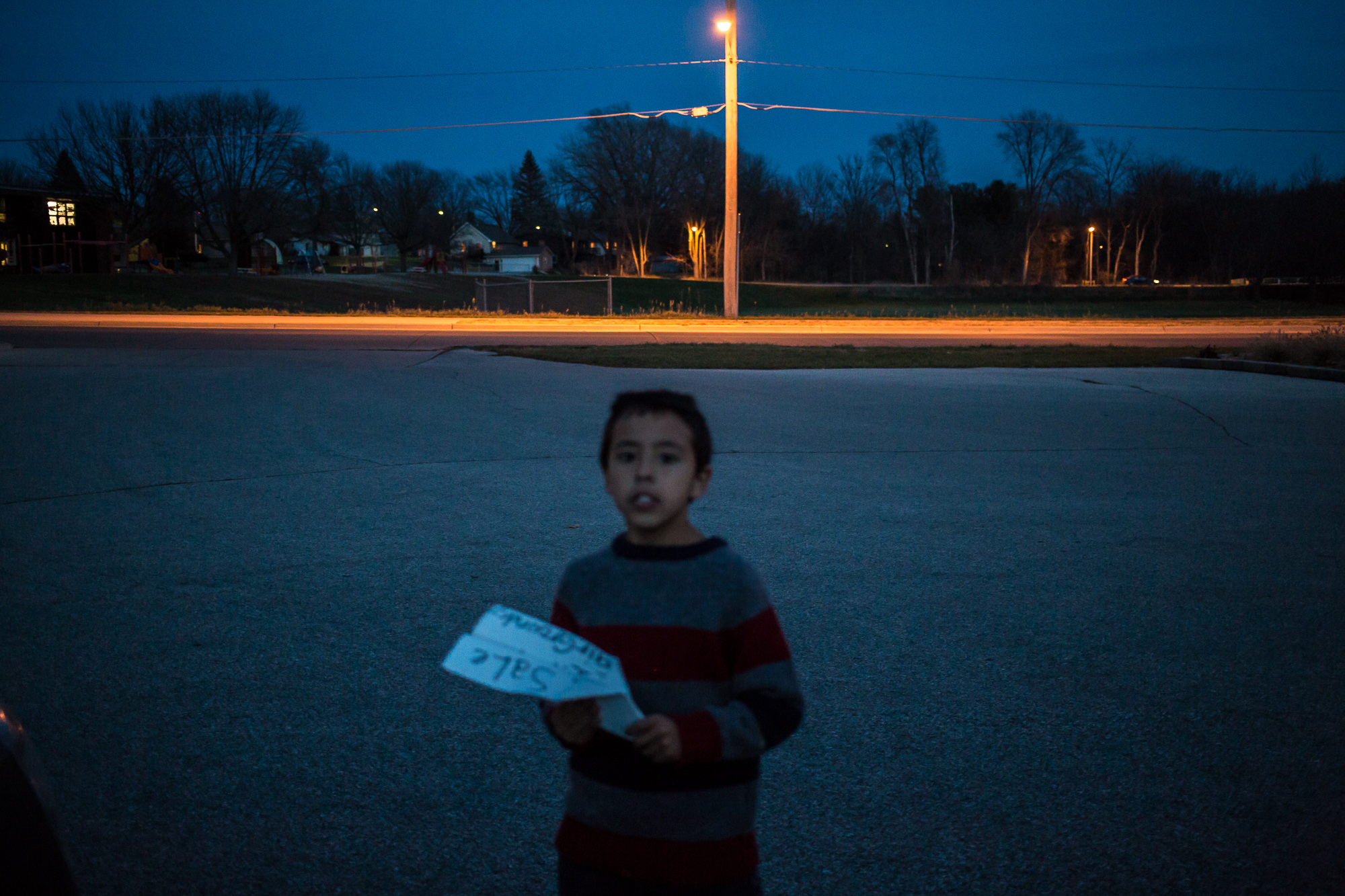  Riley Jensen holds a paper airplane made from a sign he found on Wednesday, November 14, 2012 in Webster City, IA. 