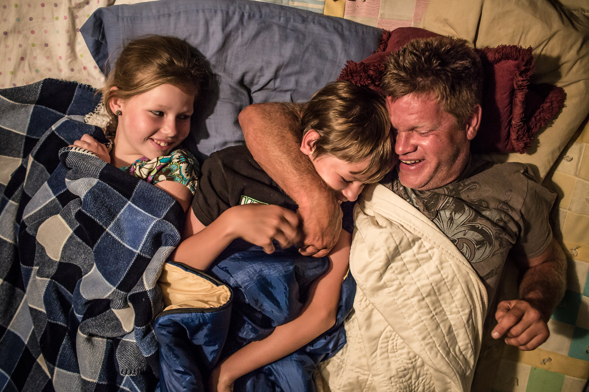  Steve McFarland lies with his daughter Alanna, left, and son Joe, center, under blankets on their back deck on Saturday, July 28, 2012 in Webster City, IA. 