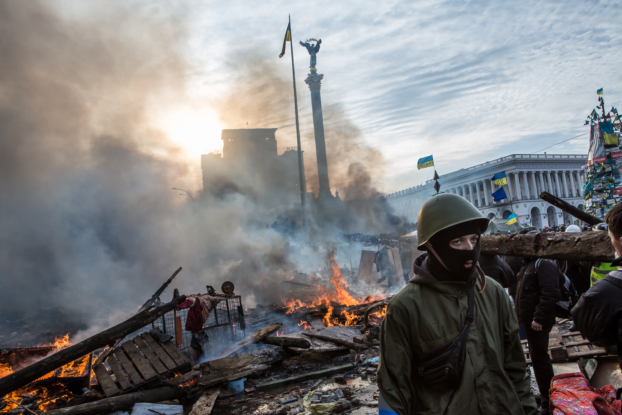  Anti-government protesters walk amid debris and flames near the perimeter of Independence Square, known as Maidan, on February 19, 2014 in Kiev, Ukraine. After several weeks of calm, violence has again flared between police and anti-government prote