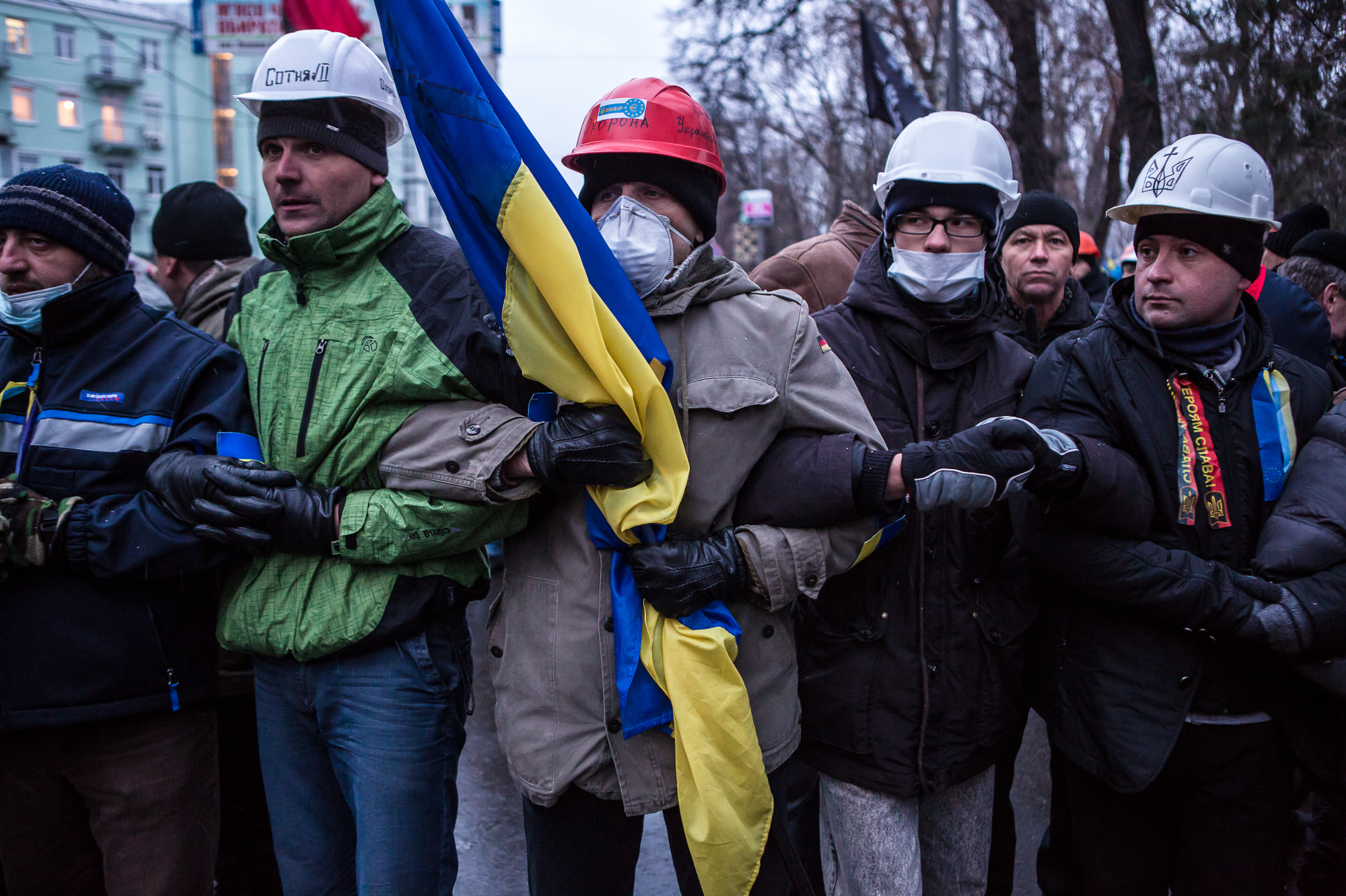  Anti-government protesters lock arms to block access to a street that leads to the Ukrainian parliament building, the site of a rally held by the ruling Party of Regions in support of the government and Ukrainian president Viktor Yanukovych, on Dece