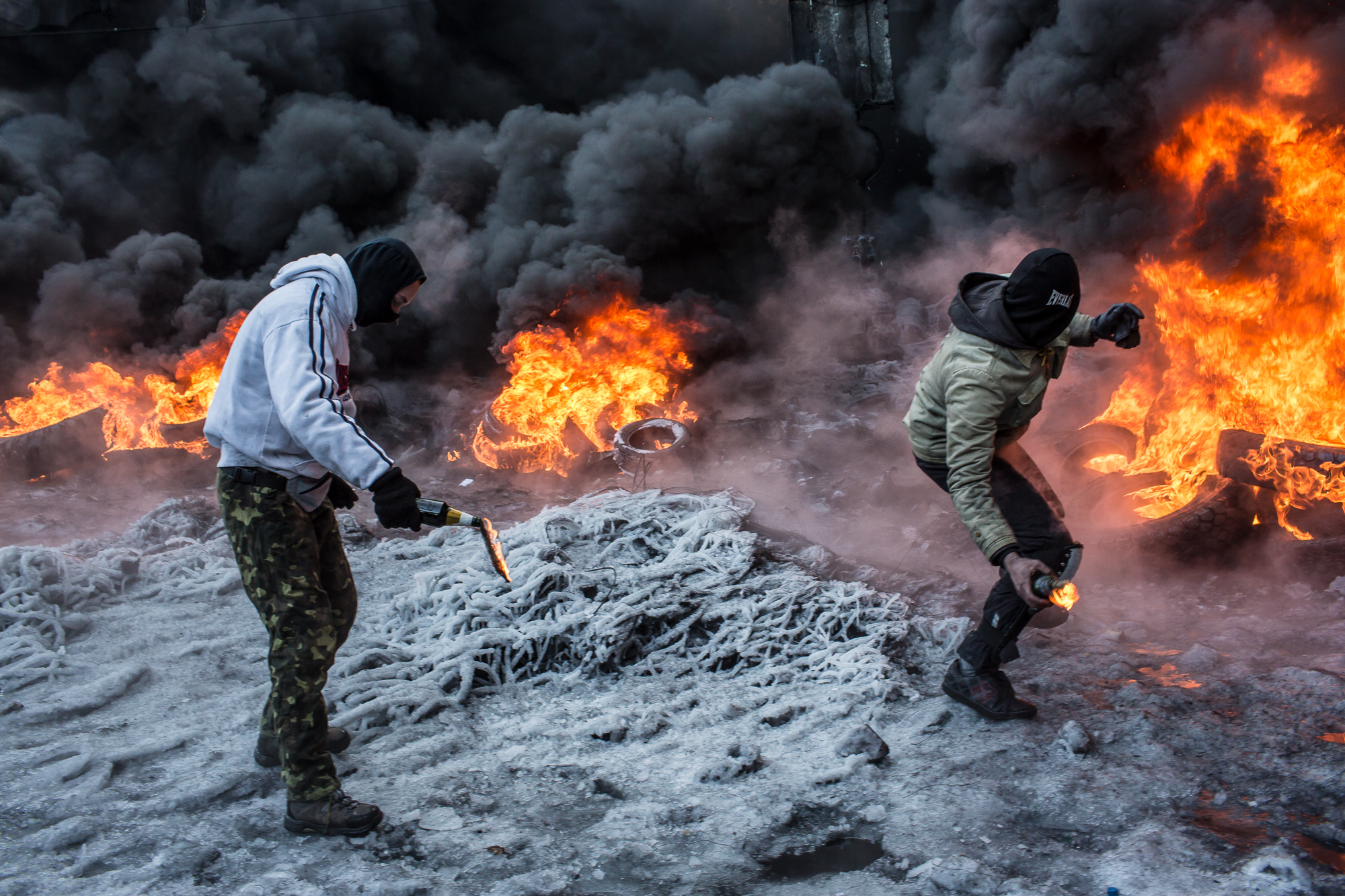  Anti-government protesters throw Molotov cocktails at police during clashes on Hrushevskoho Street near Dynamo stadium on January 25, 2014 in Kyiv, Ukraine. After two months of primarily peaceful anti-government protests in the city center, new laws