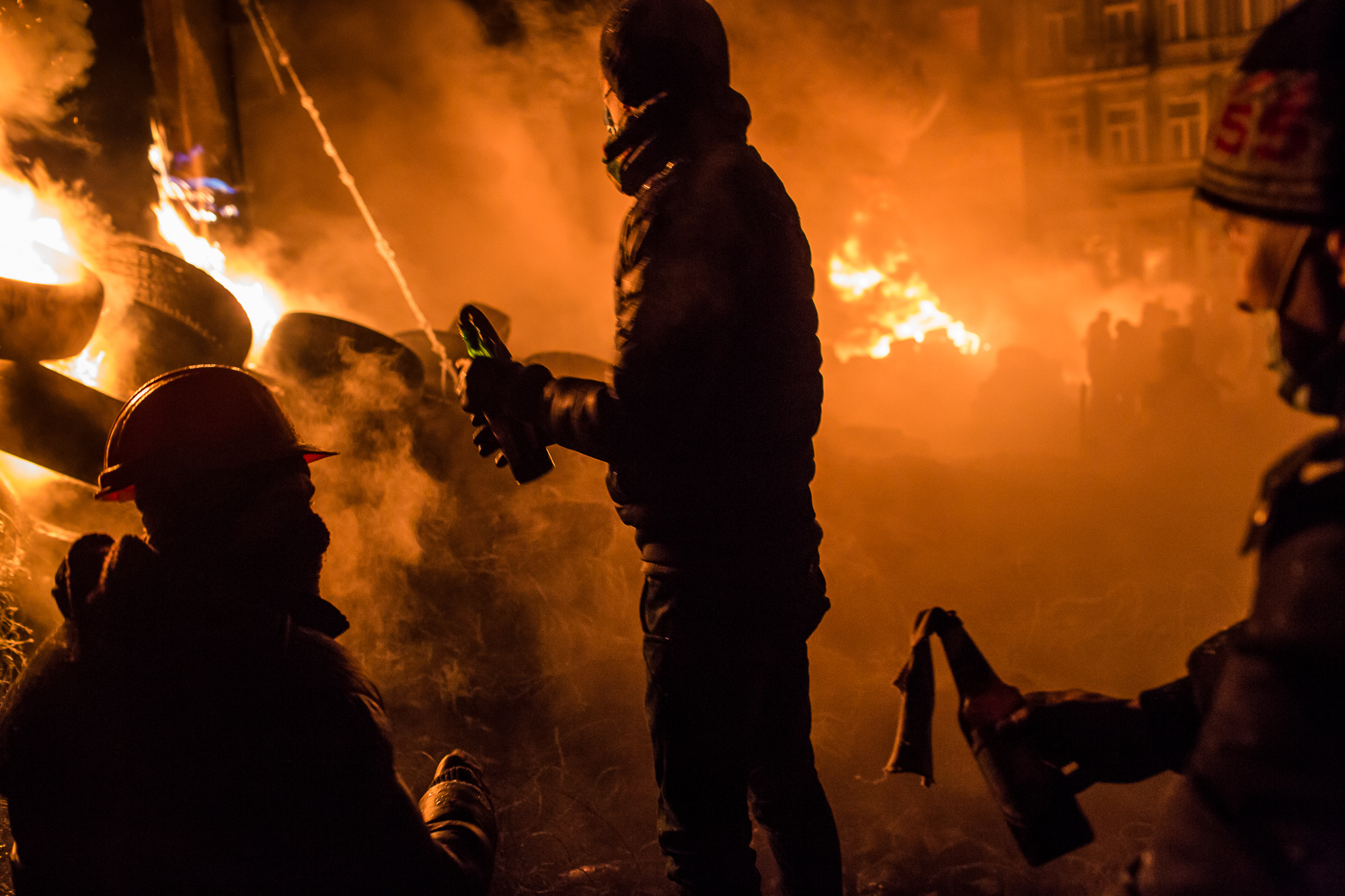  Anti-government protesters prepare to throw Molotov cocktails during clashes with police on Hrushevskoho Street near Dynamo stadium on January 25, 2014 in Kiev, Ukraine. After two months of primarily peaceful anti-government protests in the city cen